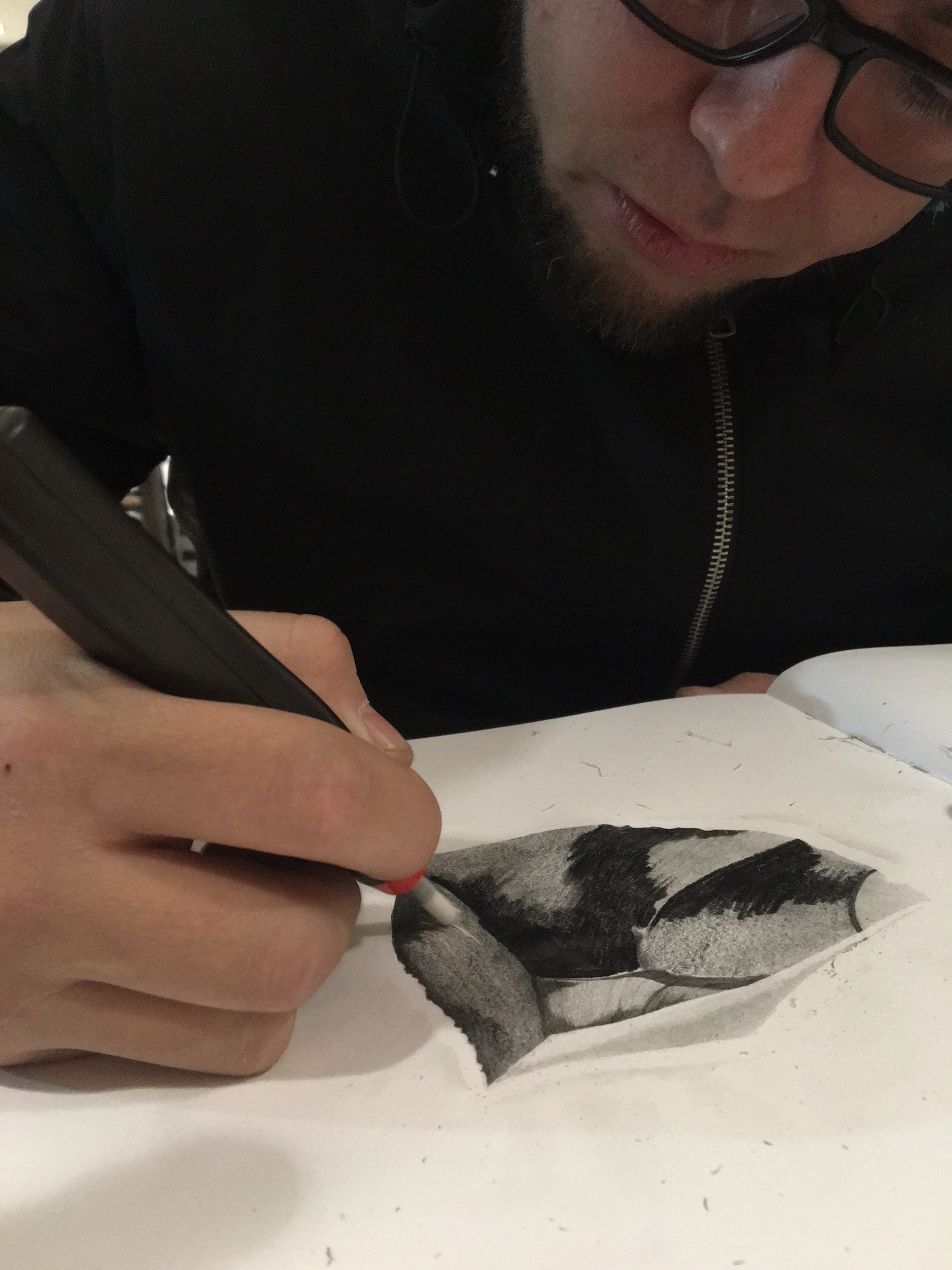 MIguel Machuca sketching with a battery-operated eraser