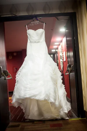 The brides BEAUTIFUL dress was form fitted just for her and purchased at Evan Grace Boutique in Concord NC.
