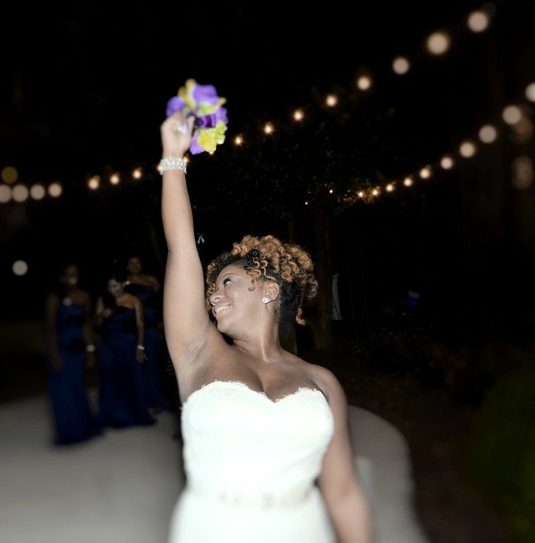 Stunning picture of the bouquet toss by Will Saunders of Freeverse Freelance Photography.