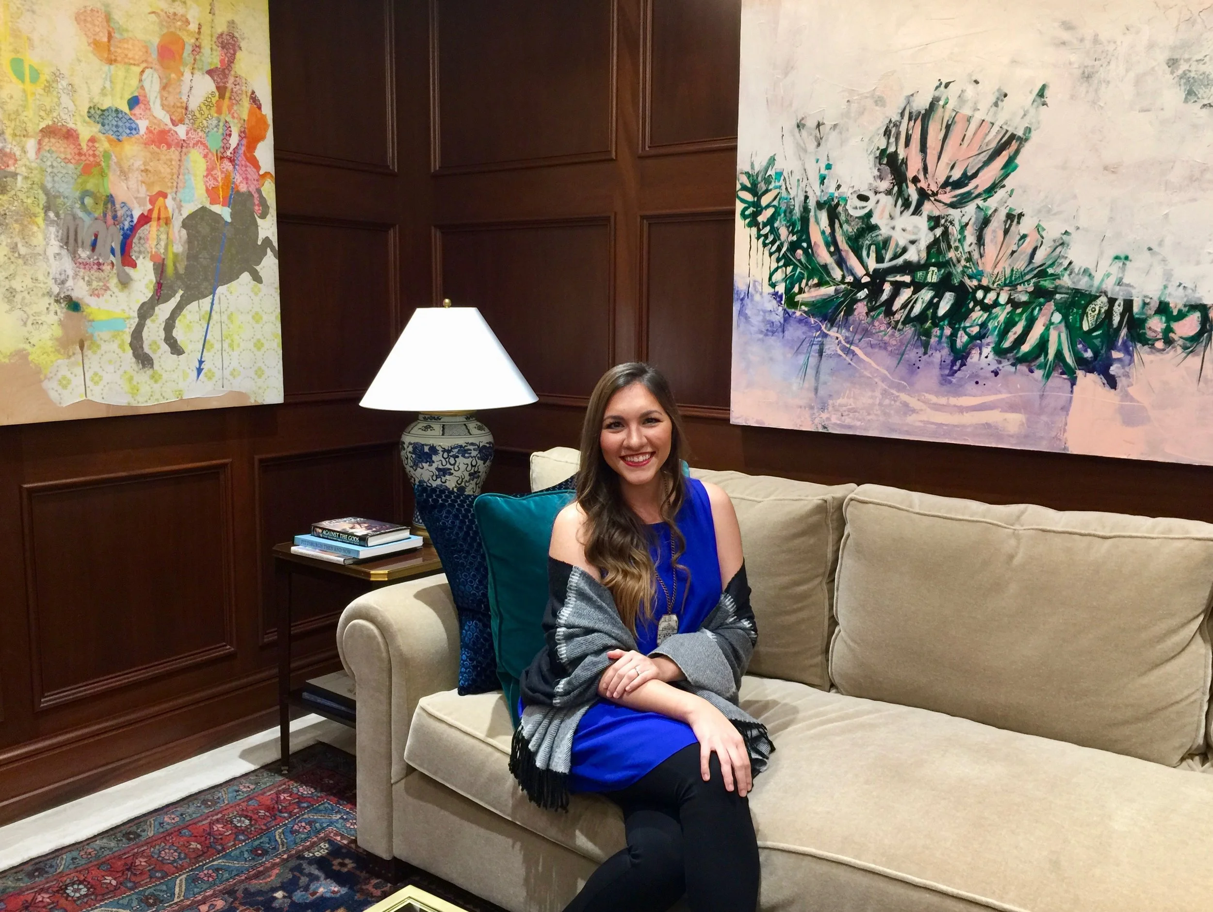 Artist Crystal Latimer between two of her paintings.