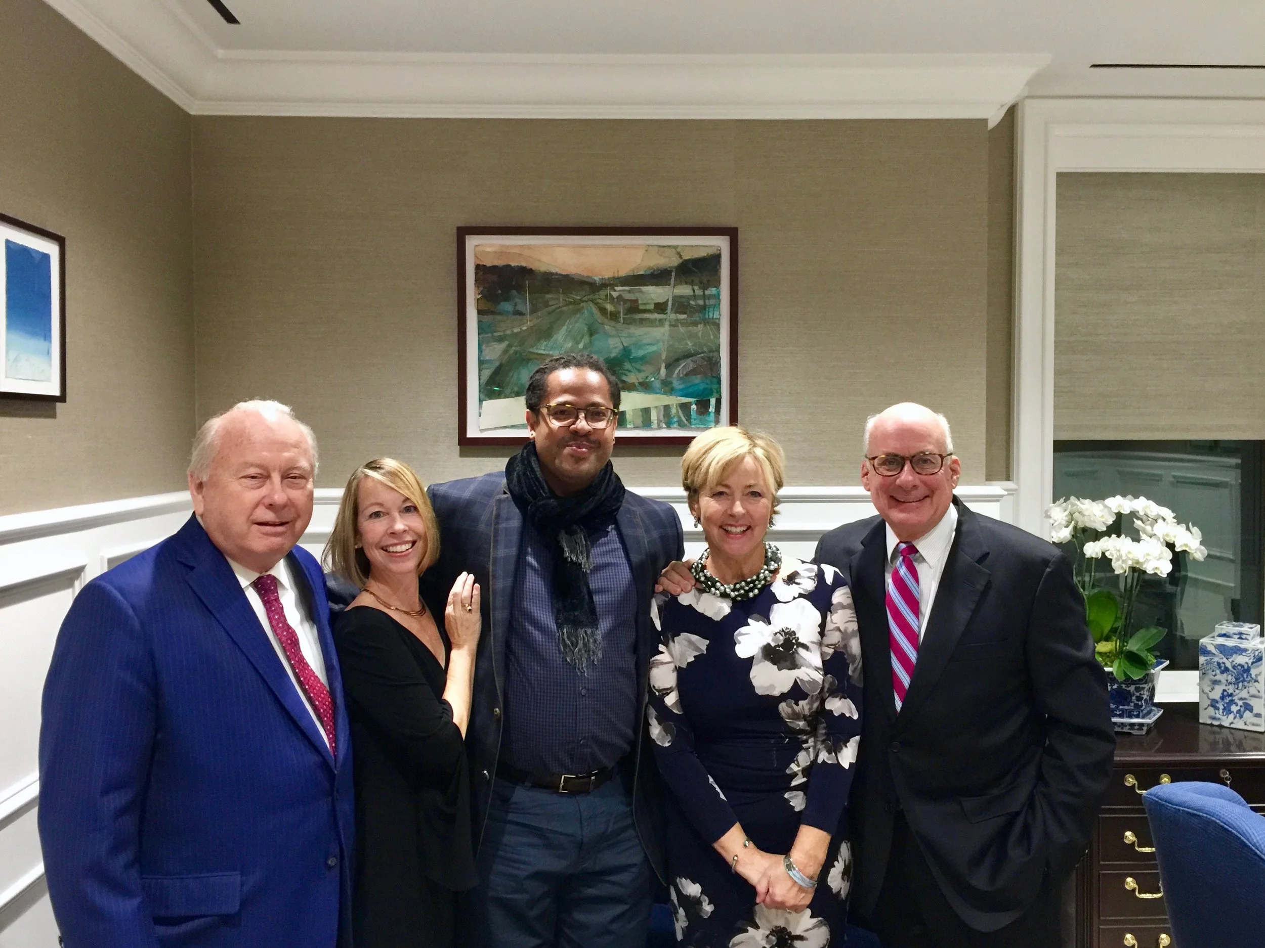 Benter Collection Artist Ramon Riley, at center, in front of his artwork.