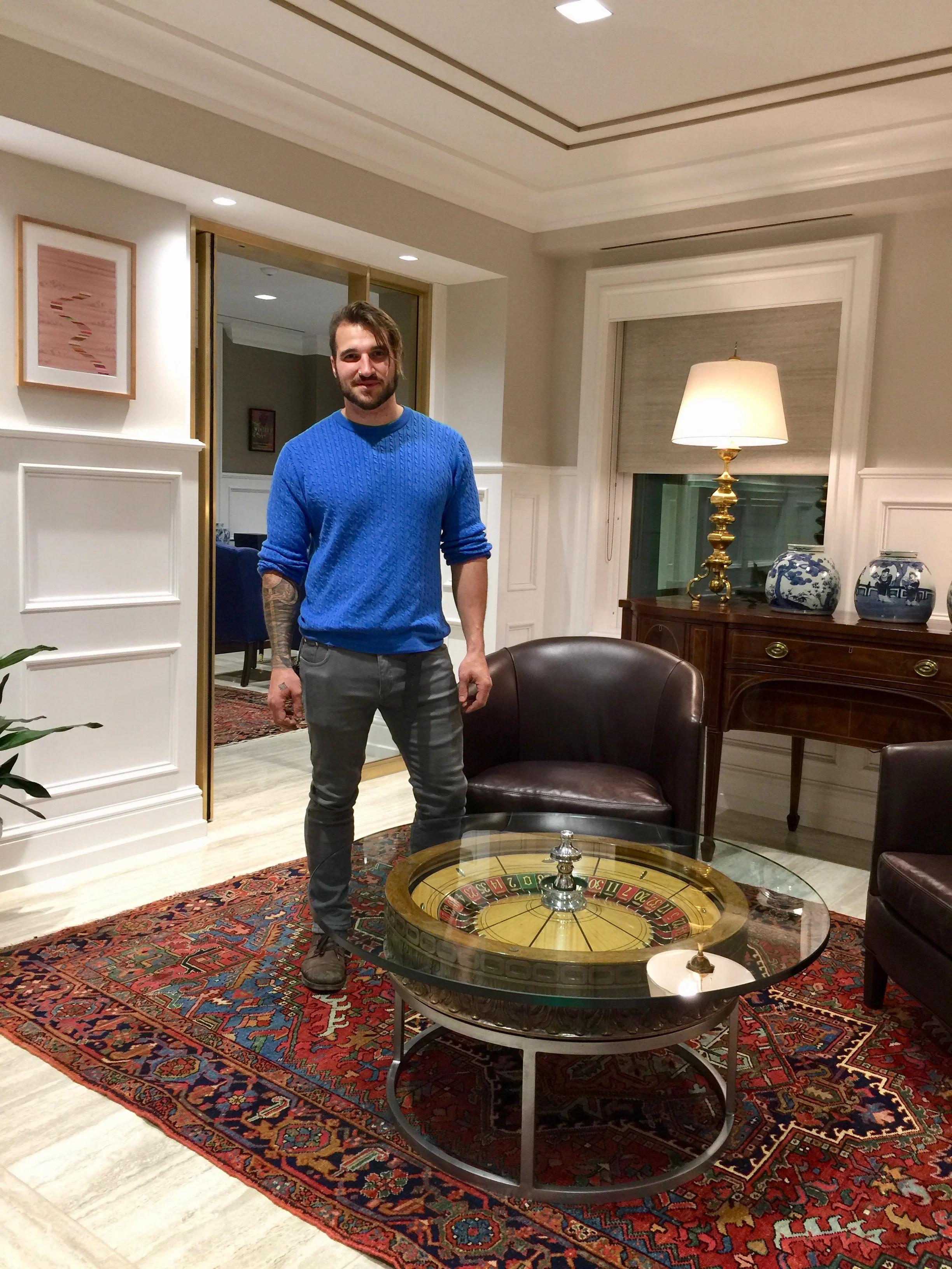 Artist, Nicholas Volpe, with his custom-crafted table made from an artifact from Bill's personal collection.