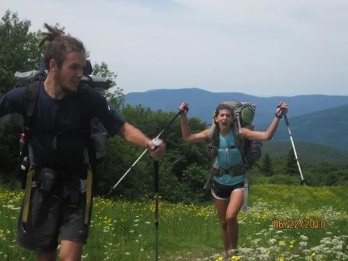 Hikers on the Appalachian Trail with flowers.