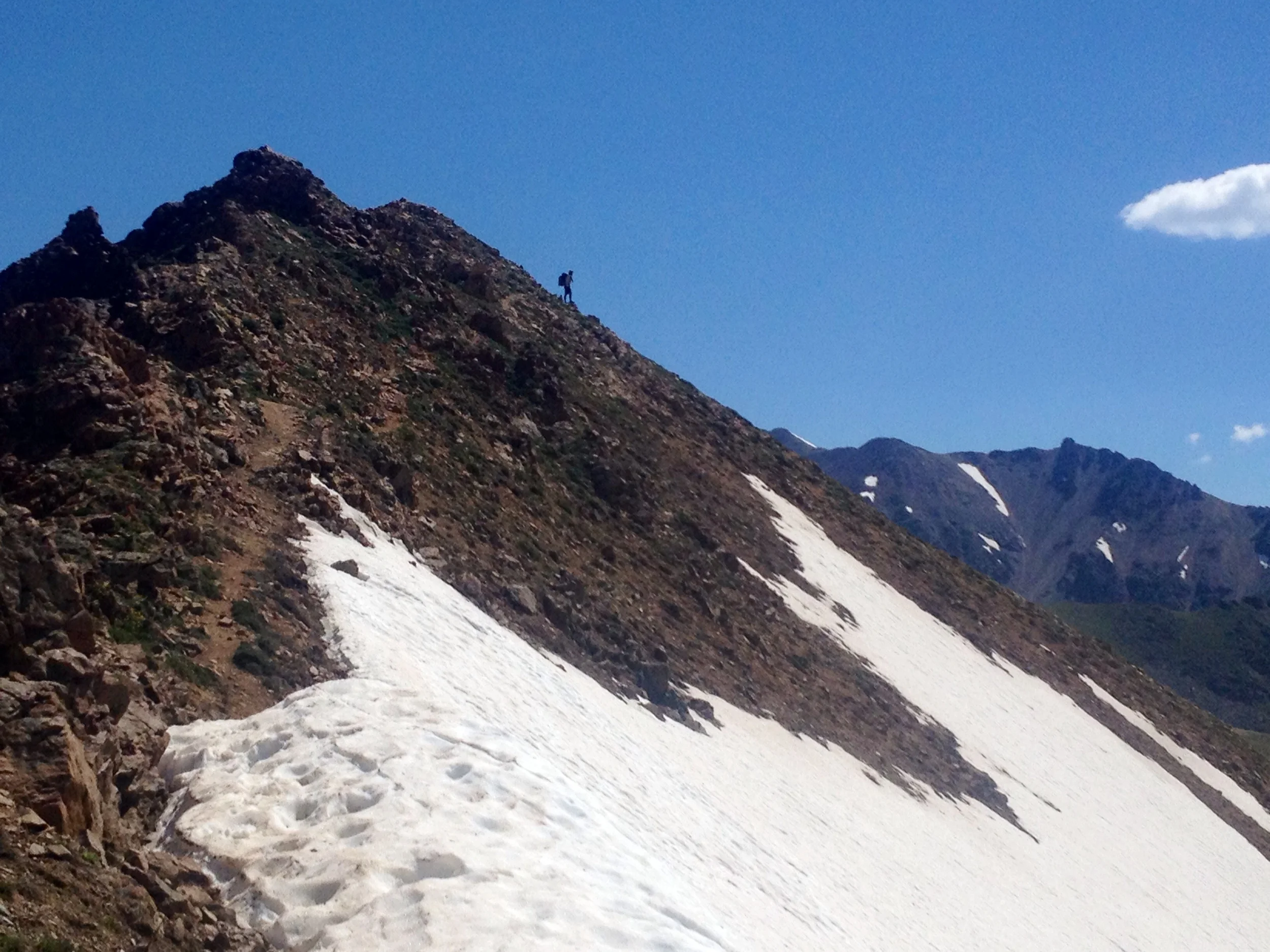 Analog climbs a peak along the Gore Range.