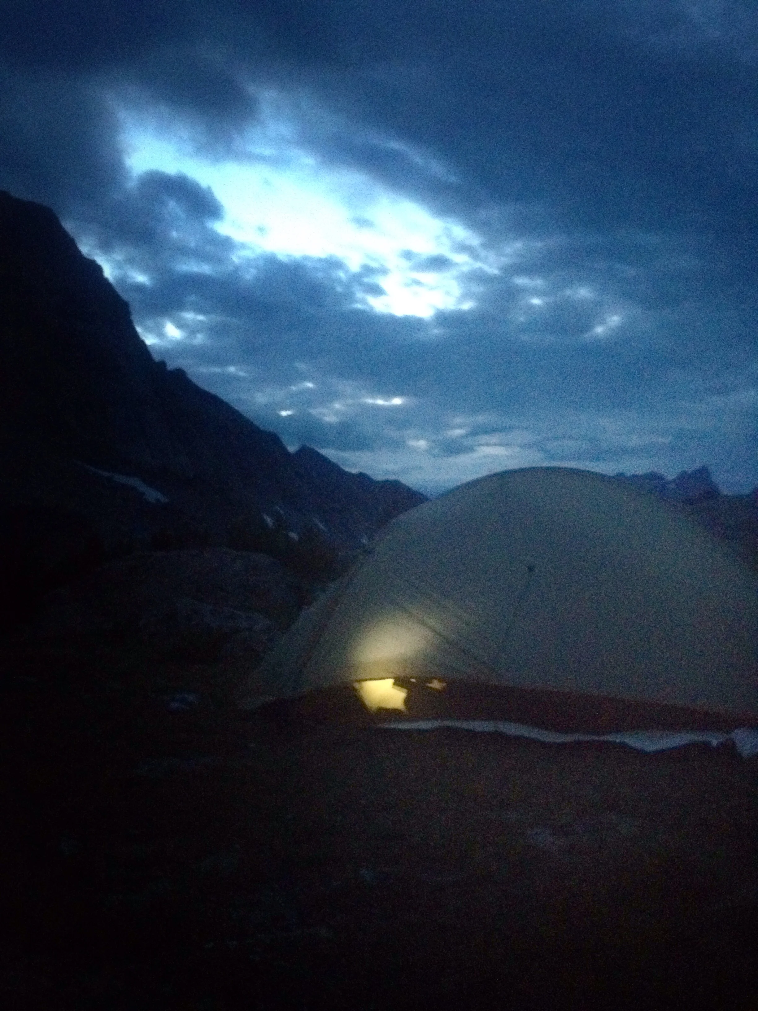 Analog's tent illuminated by headlight as he reviews the coming day's terrain.