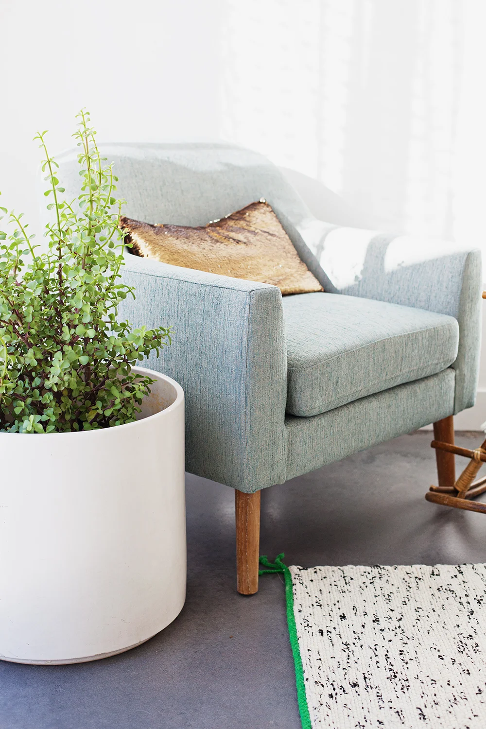 Chair from Houzz, large planter from Let Go, rug from Ikea, sequin pillow from Nordstrom Rack, plant from Home Depot