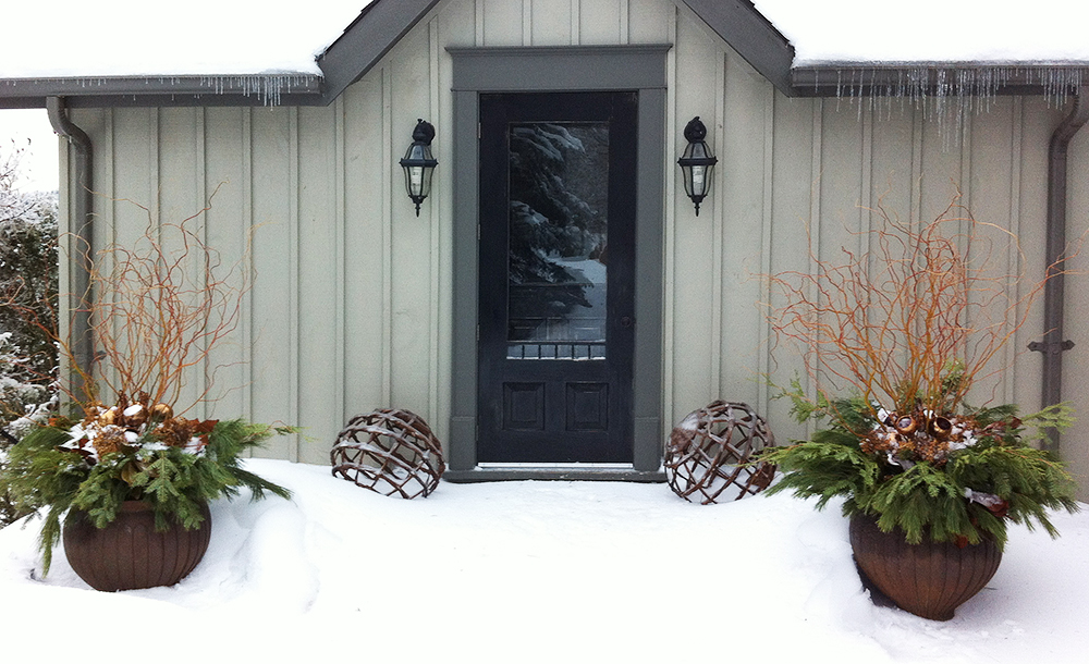 Curly willow, copper accents and woven willow globes frame the back door entrance.