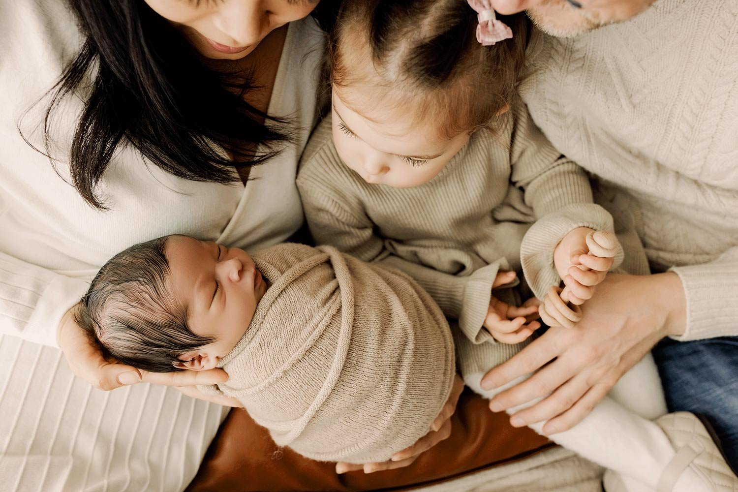 Parents and toddler cuddling newborn baby during Salem Oregon lifestyle newborn session.