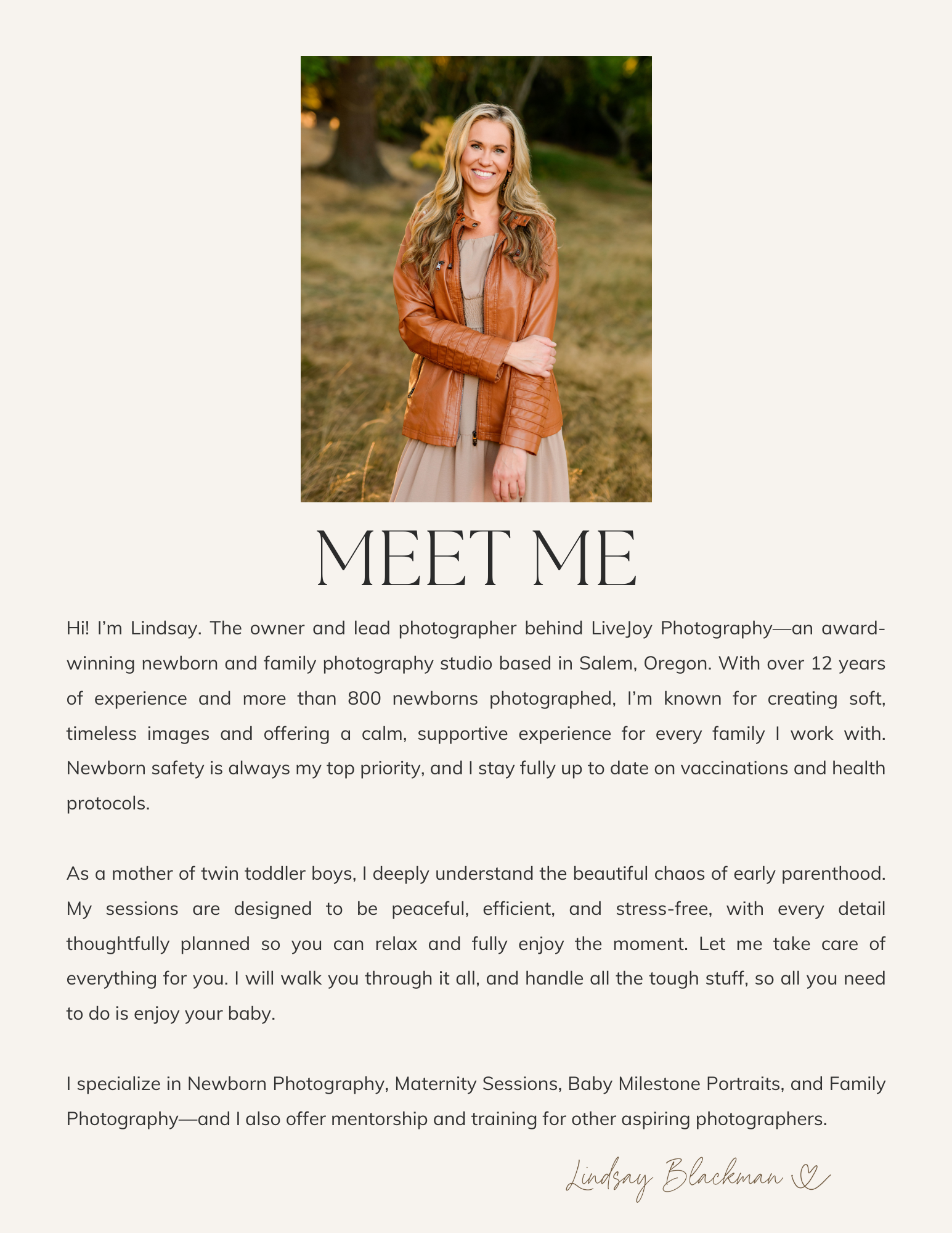 Portrait of a smiling woman with long, wavy blonde hair wearing a brown leather jacket and a beige dress, standing outdoors in a natural setting with trees and grass.