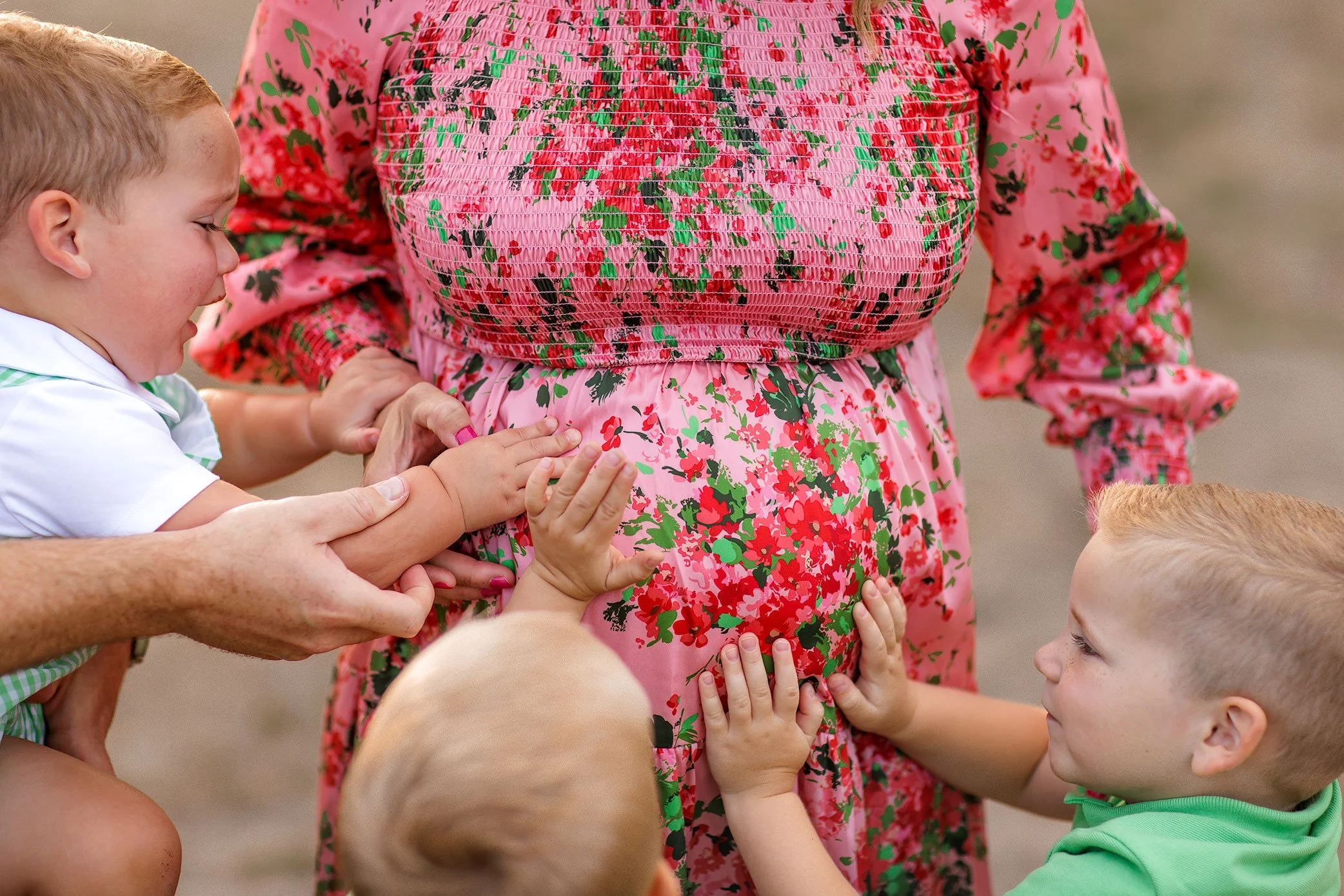 Siblings and parents placing hands on pregnant belly during family maternity session in Salem Oregon