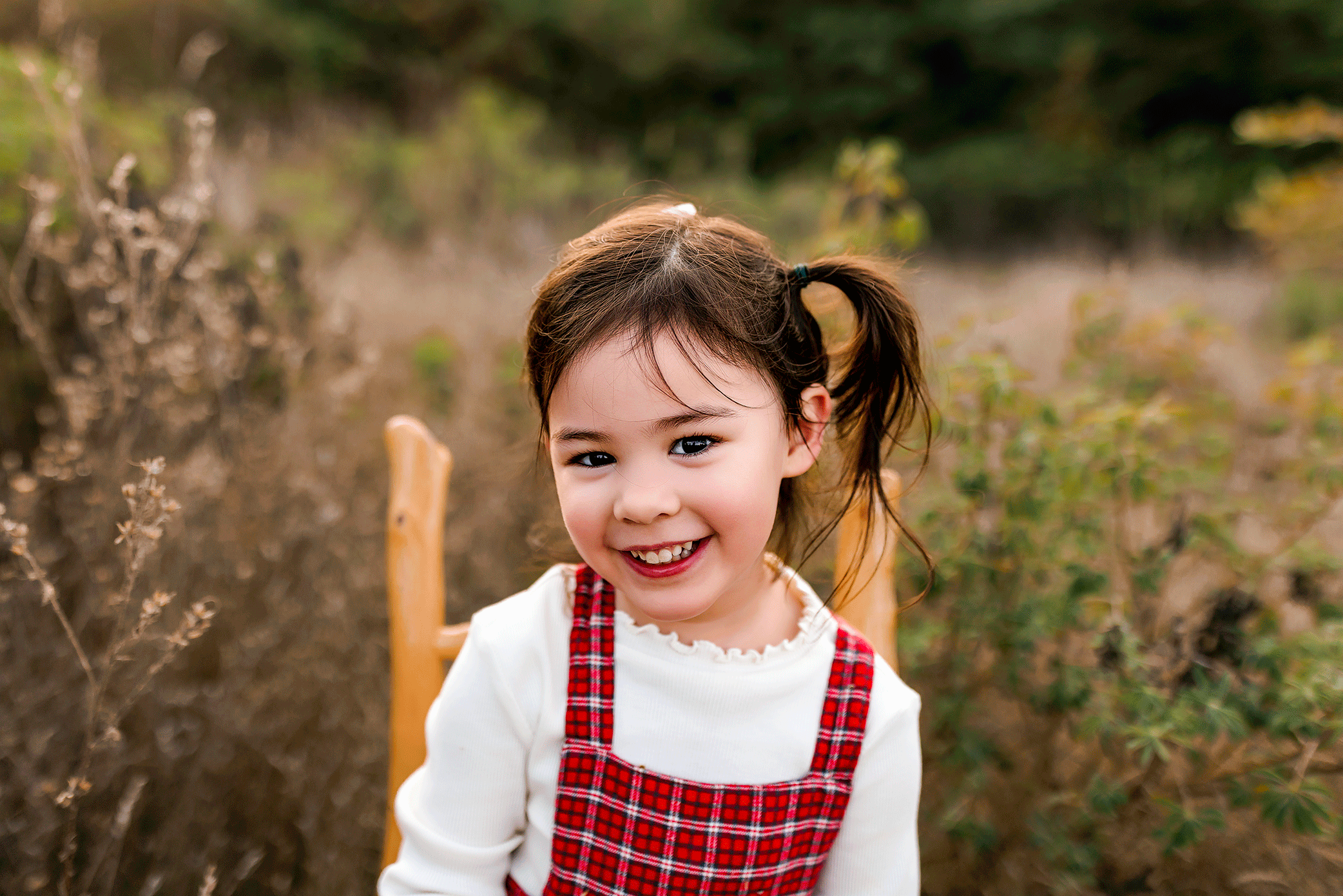 Smiling toddler girl photographed outdoors during a natural family photography session in Salem, Oregon.