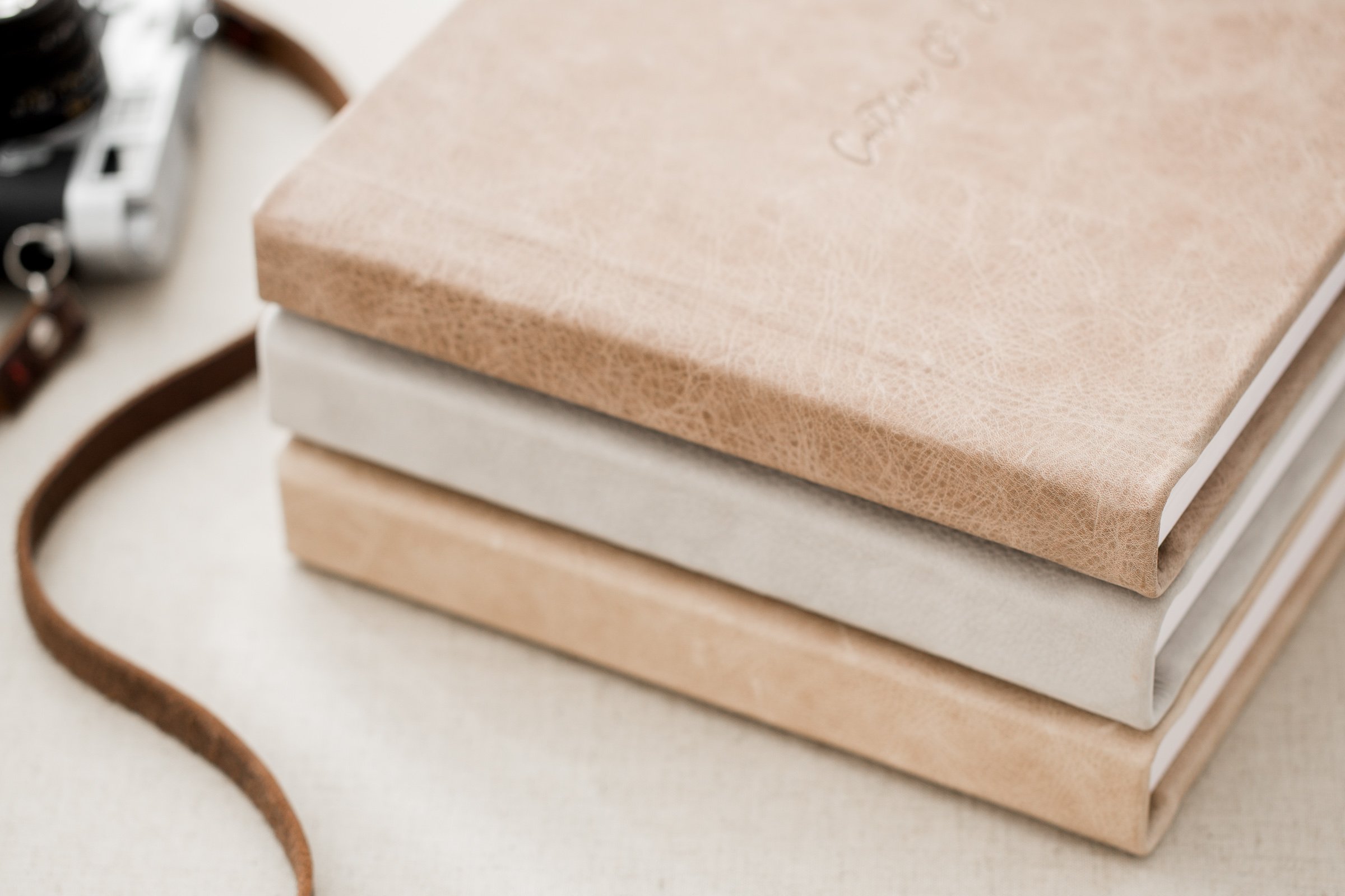 Close up of heirloom photography album with soft leather cover and stacked pages