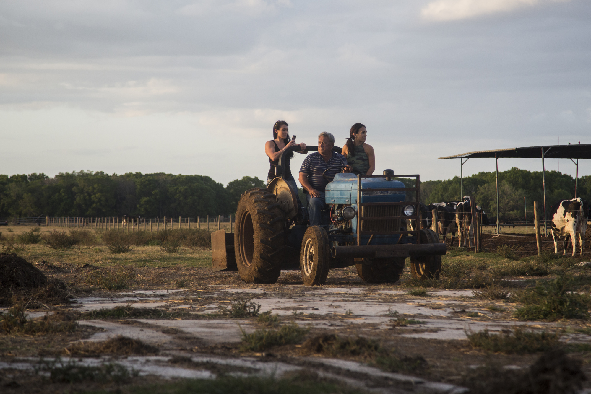  Savannah Busciglio, Sammy Busciglio, and Samantha Busciglio-Payne ride on a tractor back to the barn at Tower Dairy, after taking a family portrait on March 26, 2017. Savannah and Samantha are Sammy's daughters.&nbsp;  "I wish there was some way we 