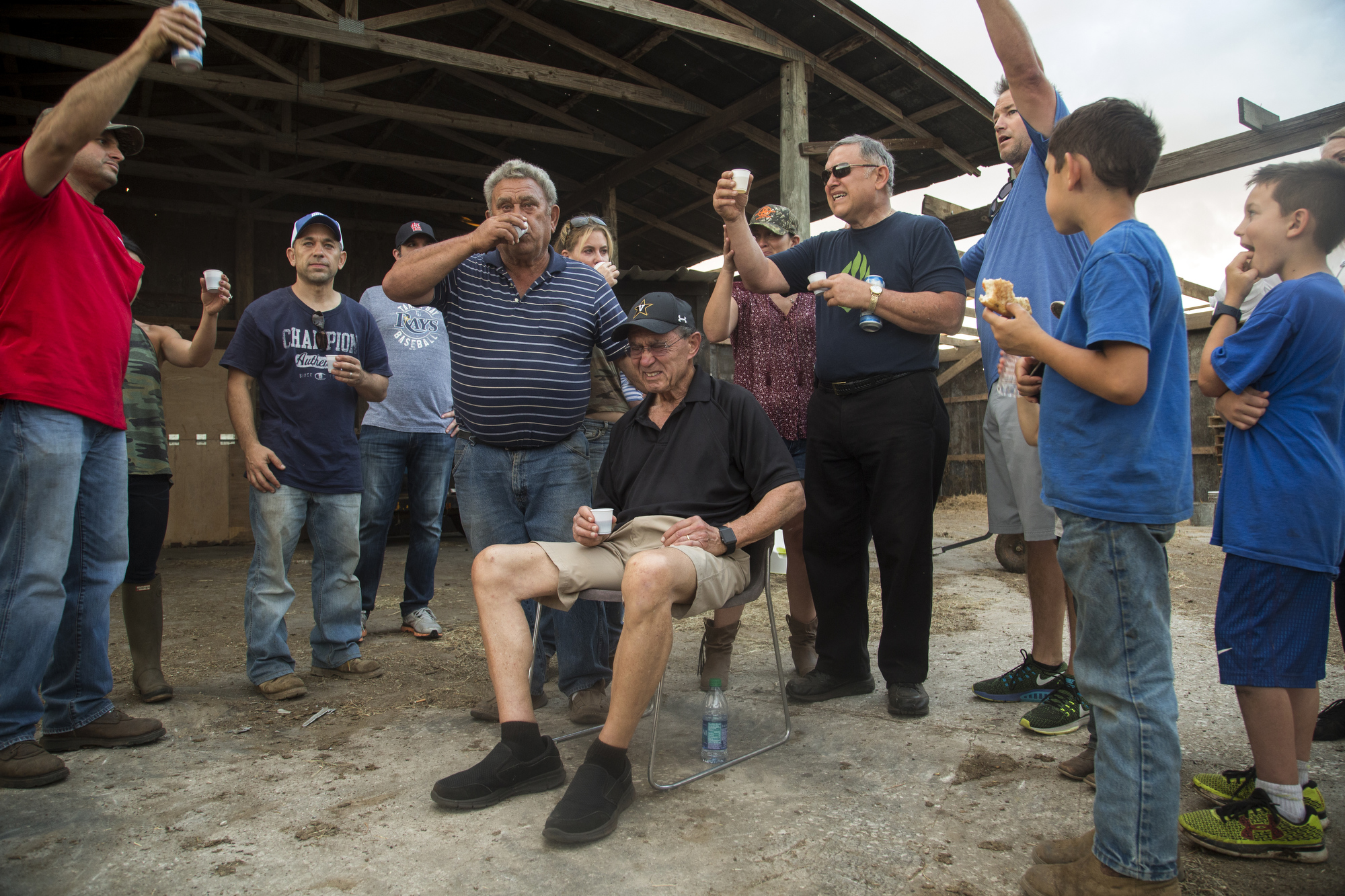  Sammy Busciglio (left of center), his two brothers and extended family toast to Tower Dairy and the Busciglio family with wine and Busch beer, on March 26, 2017, the day before the cows were moved to Georgia. Sammy's father Joe Busciglio loved to dr