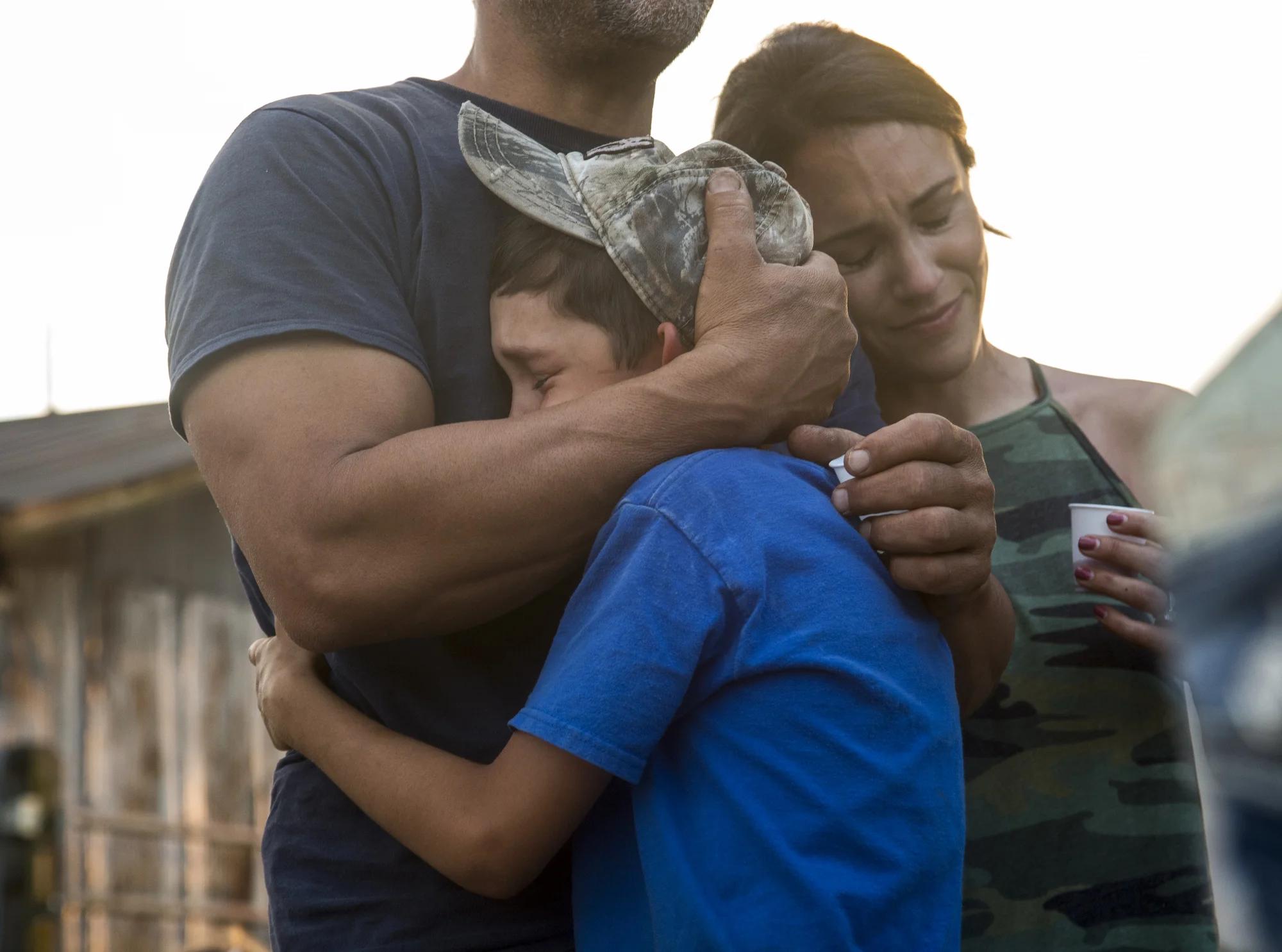 Jeff Busciglio hugs his son Alex Busciglio, 9, while his sister Samantha Busciglio-Payne, leans on this shoulder, after a family toast to Tower Dairy got emotional, on March 26, 2017.