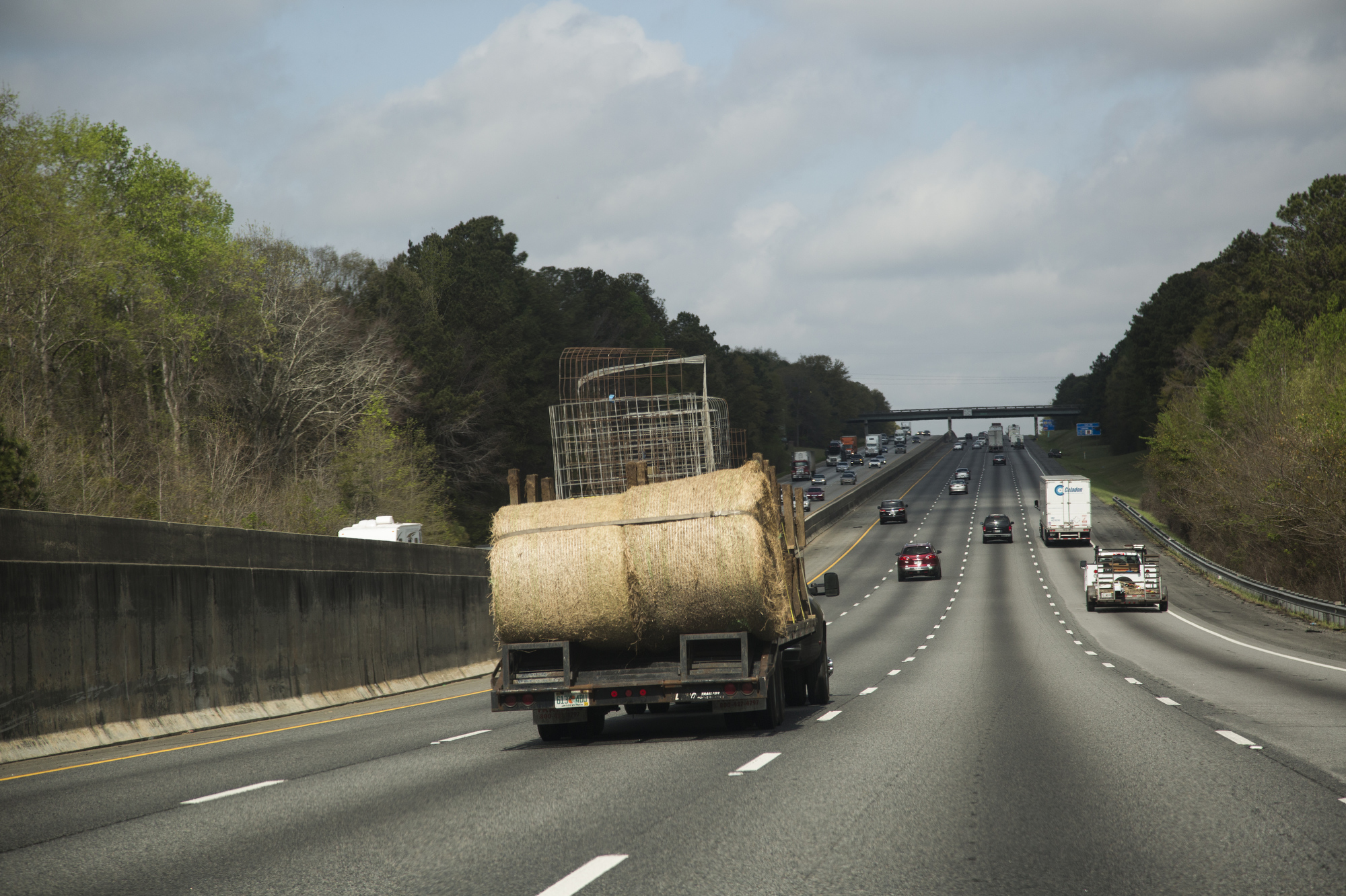  Sammy Busciglio drives a truck loaded with feed troughs, calf pins and bales of hay north on I-75 from Tampa to the new farmland in Gay, Georgia, on March 27, 2017. The new property is 270 acres, and the family hopes to expand their herd. 