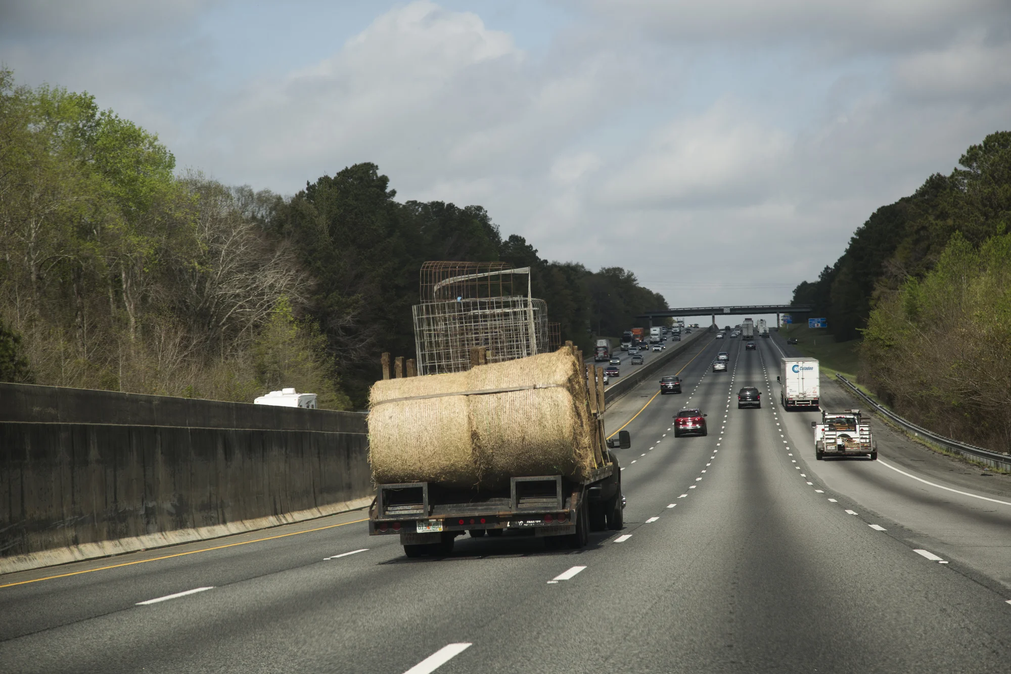 Sammy Busciglio drives a truck loaded with feed troughs, calf pins and bales of hay north on I-75 from Tampa to the new farmland in Gay, Georgia, on March 27, 2017. The new property is 270 acres, and the family hopes to expand their herd.
