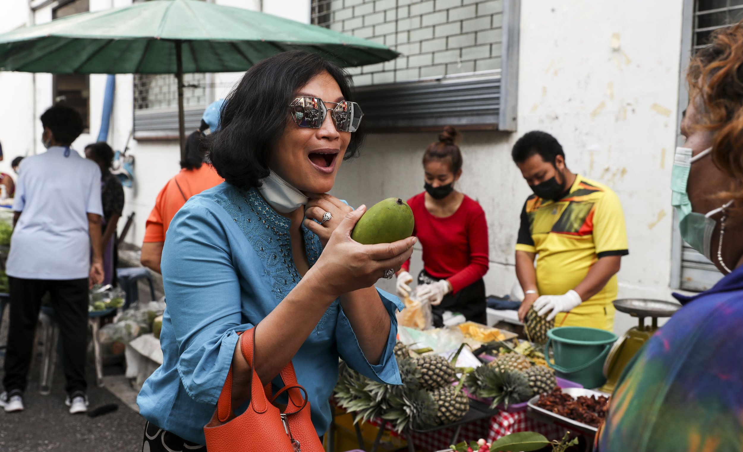  Chutatip “Nok” Suntaranon reacts to a fragrant mango at the market in Trang, Thailand on Saturday, April 16, 2022. "I've been away from home for a very long time," Nok said. "In order for me to be able to present it in a very correct way... I need t