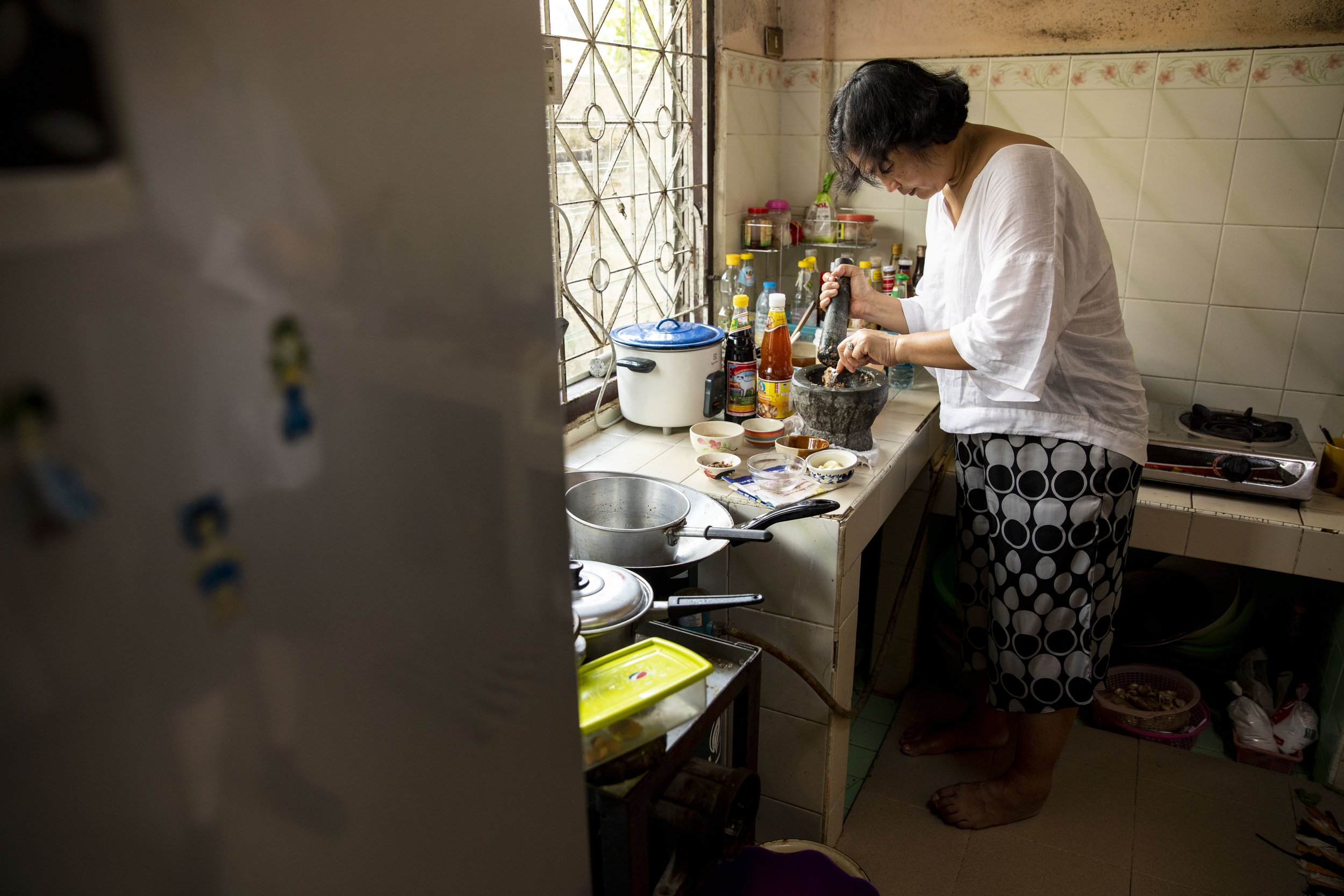  Chutatip “Nok” Suntaranon prepares a relish in her family's home in Yantakhao, Thailand on Saturday, April 16, 2022. "I went back home this time hoping to cook with my mother, but it turned out that my mother was not well enough to cook with me," No