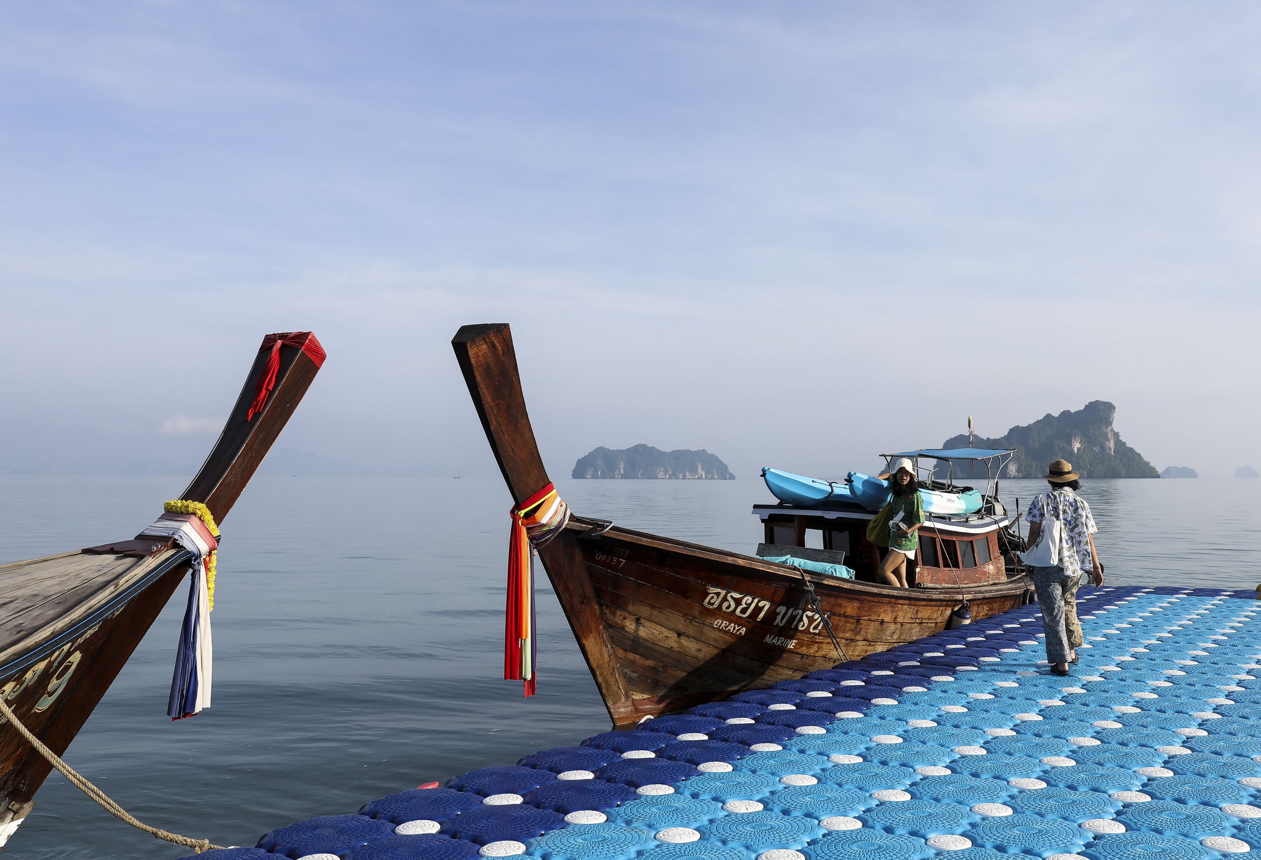  (center) Chutatip “Nok” Suntaranon walks toward a long-tail boat for a morning fishing trip in Koh Yao Noi, Thailand on Tuesday, April 19, 2022. Koh Yao Noi is an island in the Andaman Sea between Phuket and Krabi.  