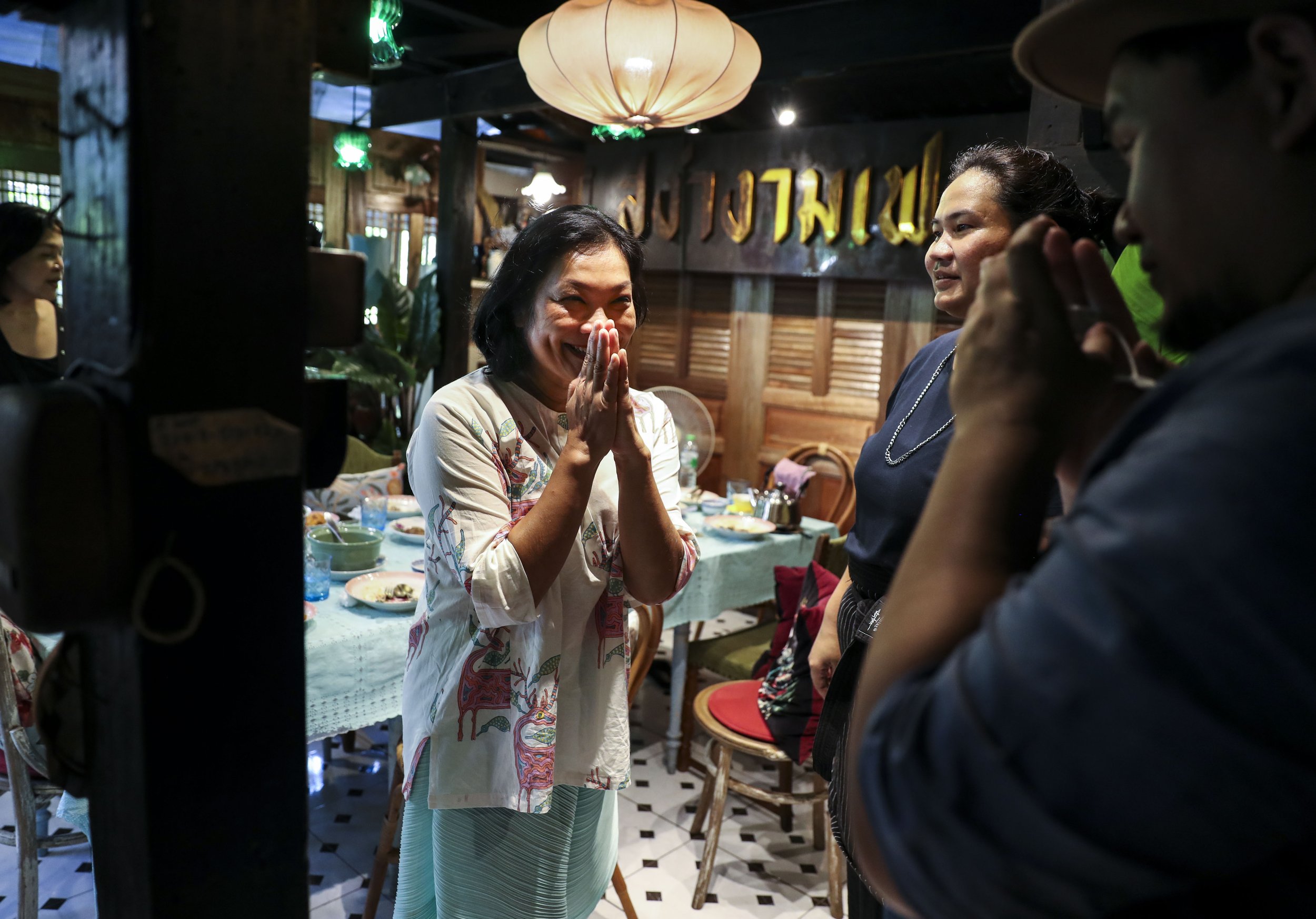  (Center) Chutatip “Nok” Suntaranon thanks (second from right) Yuwarat Sakornsin and (right) her brother Sittisak Sakornsin after a meal at their restaurant, Baan Nual in Bangkok, Thailand on Friday, April 22, 2022.  