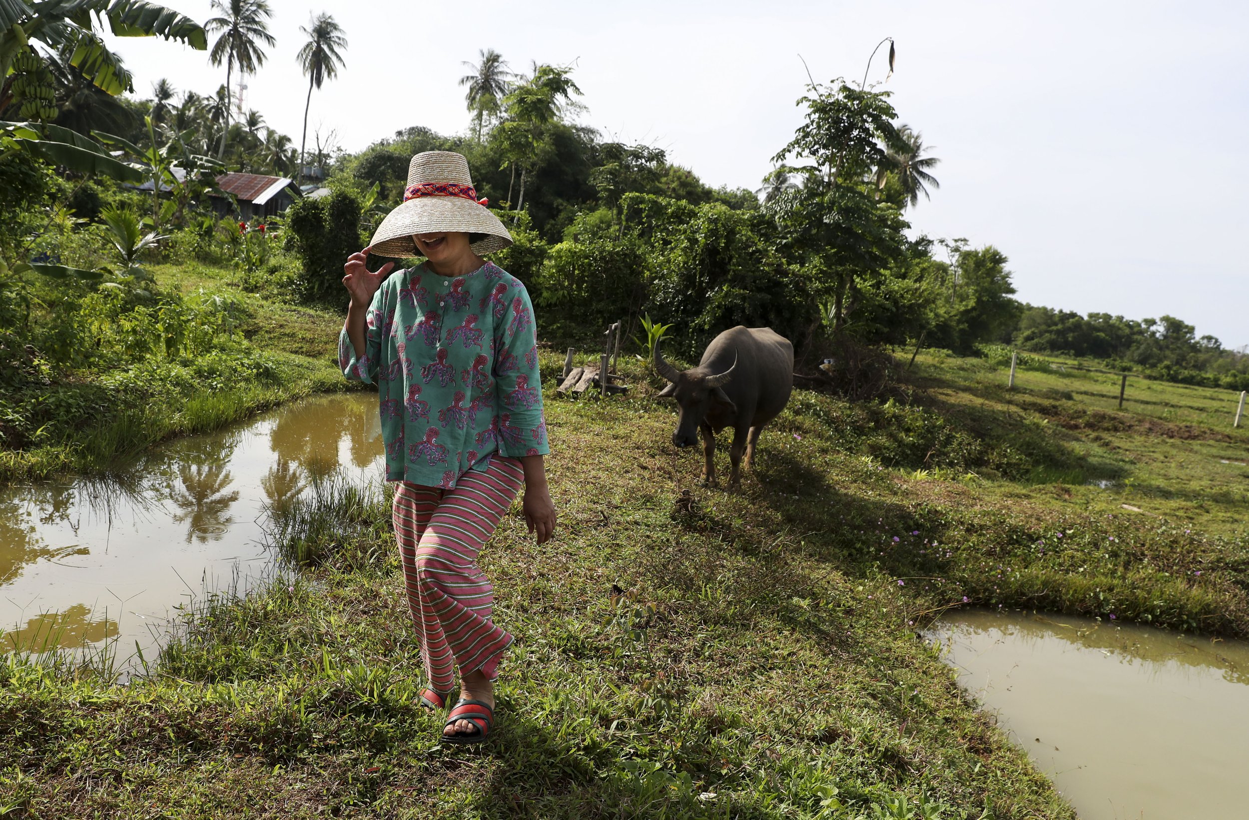  Chutatip “Nok” Suntaranon walks away from a water buffalo after approaching for a photograph on a farm in Koh Yao Noi, Thailand on Wednesday, April 20, 2022.  