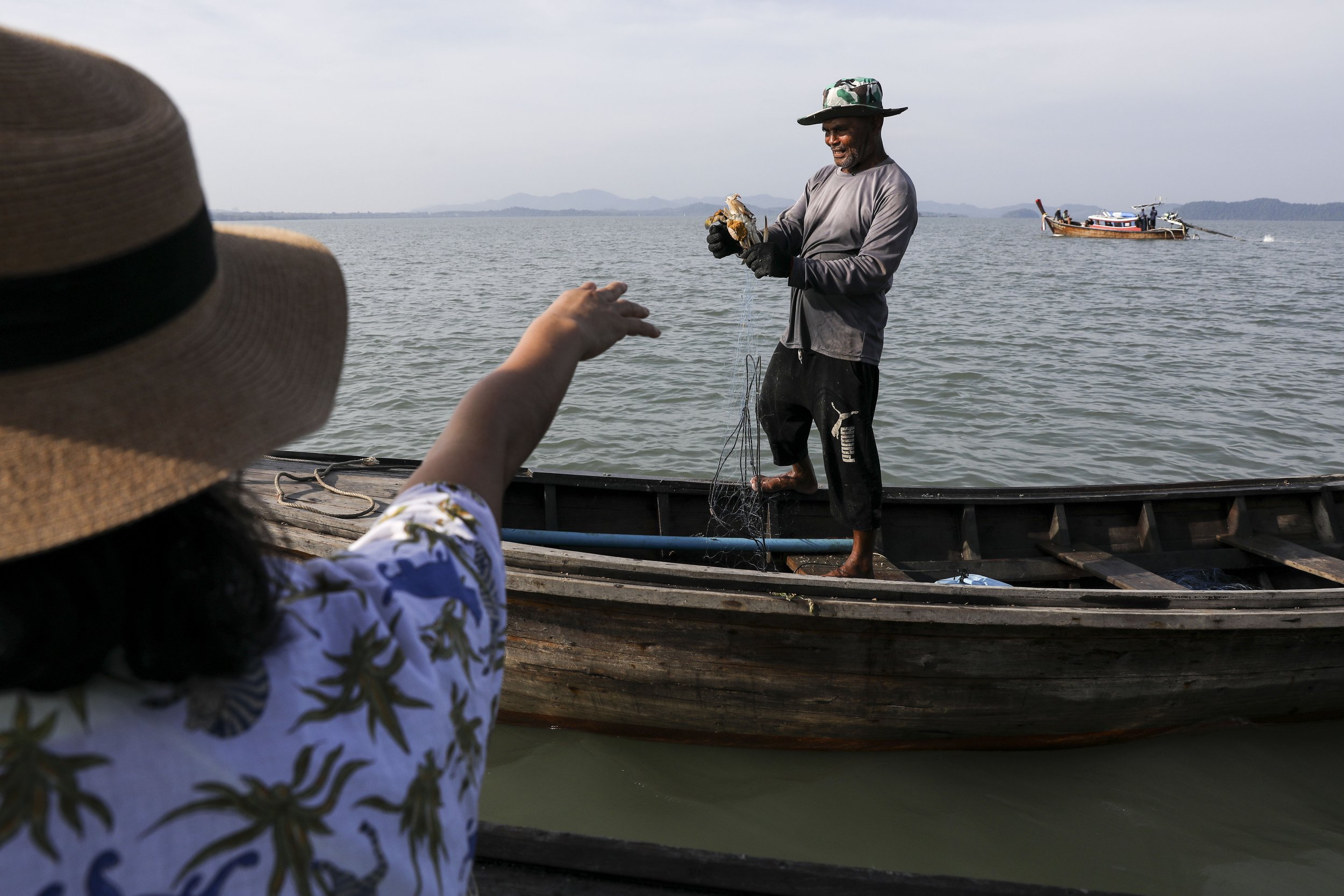  Chutatip “Nok” Suntaranon talks with a fisherman off of Koh Yao Noi, Thailand on Tuesday, April 19, 2022. "Southern people are all about genuine hospitality and broad smile and food... Southern people are proud people," Nok said of the visit to Koh 
