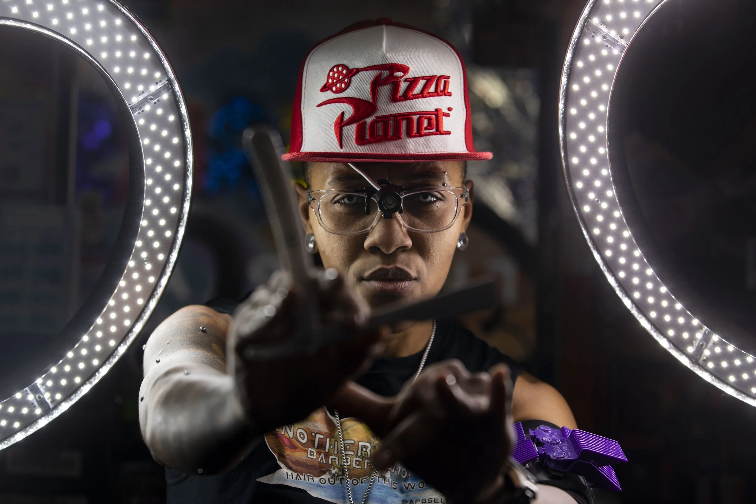  Barber Jacque "Sci-fi" Scott posed for a portrait holding a straight razor at Another Planet Barber Shop in Philadelphia, Pa. on Monday, March 16, 2020. The decor in the shop is inspired by Toy Story, specifically the scenes at Pizza Planet.  