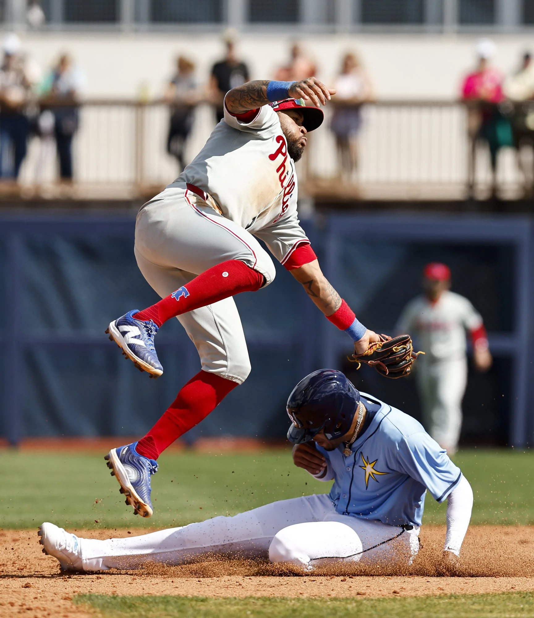  Philadelphia Phillies second baseman Edmundo Sosa makes a catch over Tampa Bay Rays left fielder Christopher Morel during the fourth inning of the Philadelphia Phillies spring training game against the Tampa Bay Rays at Charlotte Sports Park on Tues