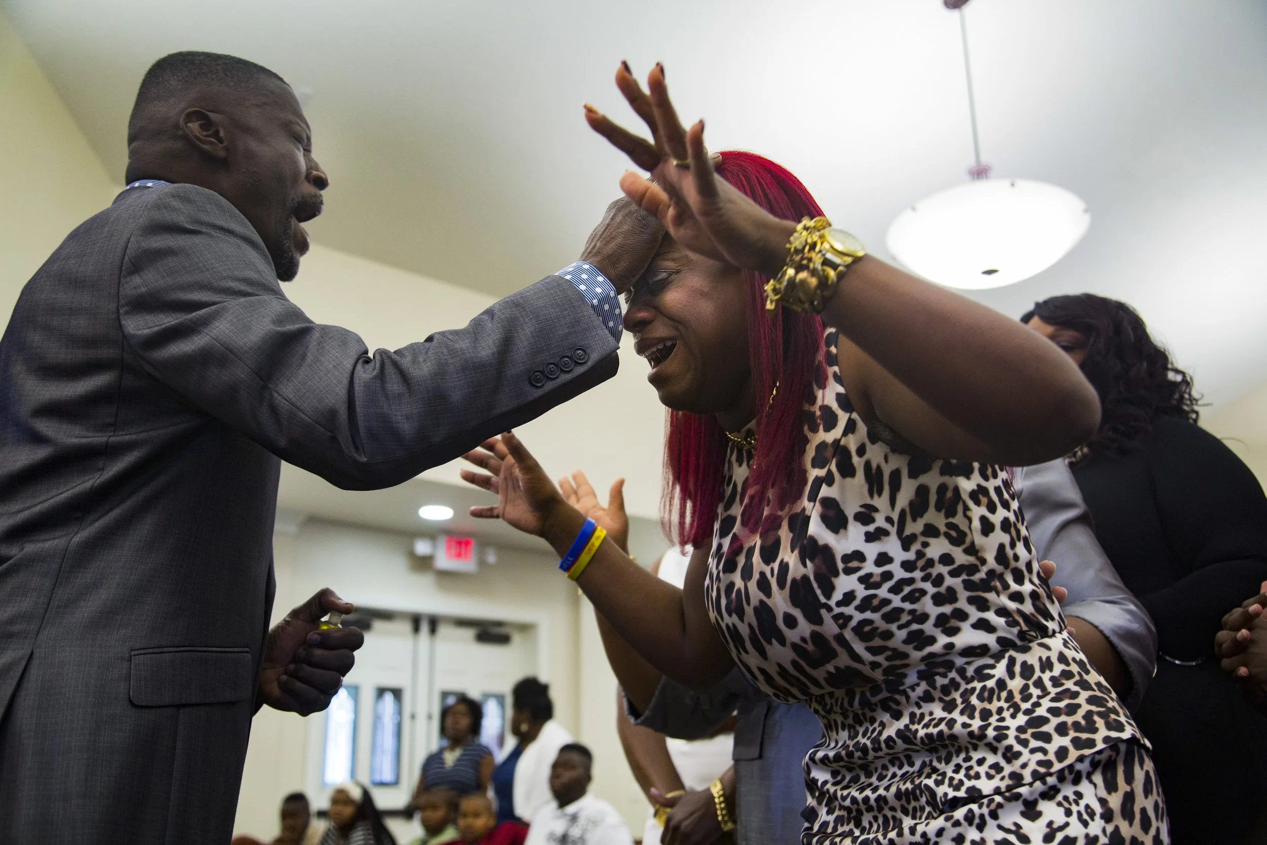  Pastor Frank Jenkins greets Natasha Clemons in the prayer line during service at Faith Temple in Palmetto, Fla. on Sunday May 15, 2016. 