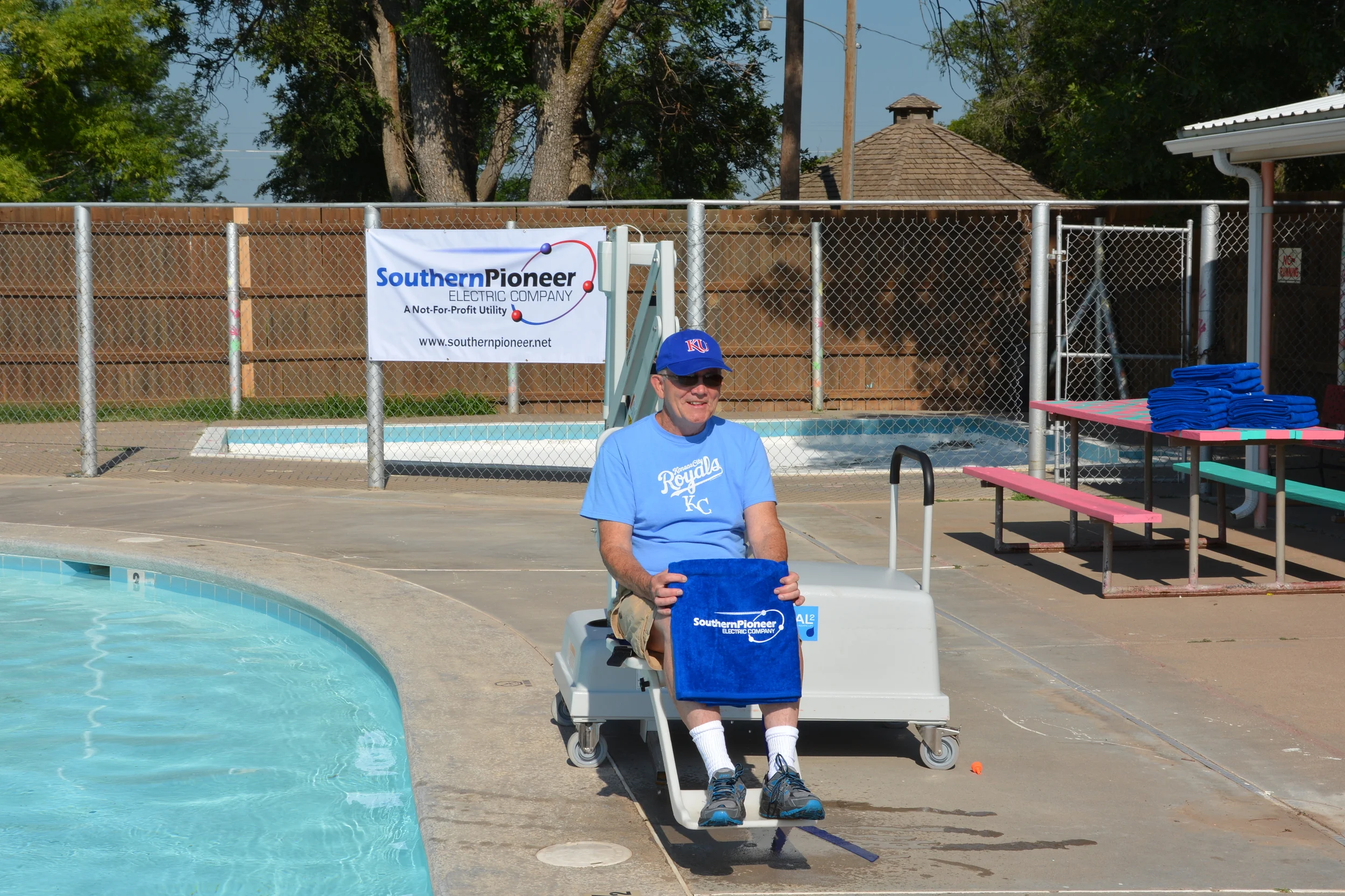 Mayor of Sublette, Jery Bailey- poses for a picture in the new mobile chair lift purchased with H.U.G.S. funds for the Sublette City pool.
