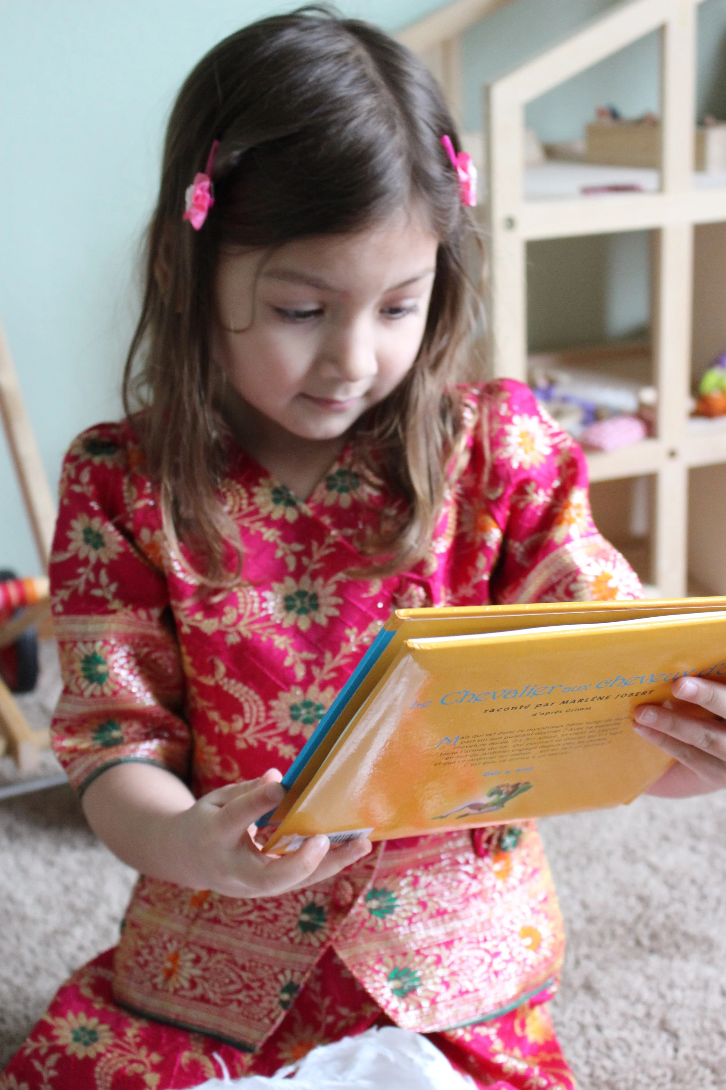 My daughter looking at a French book she received on International Book Giving Day in February. Thanks to Annika at Journal of A Bilingual Family for setting up the book exchange!
