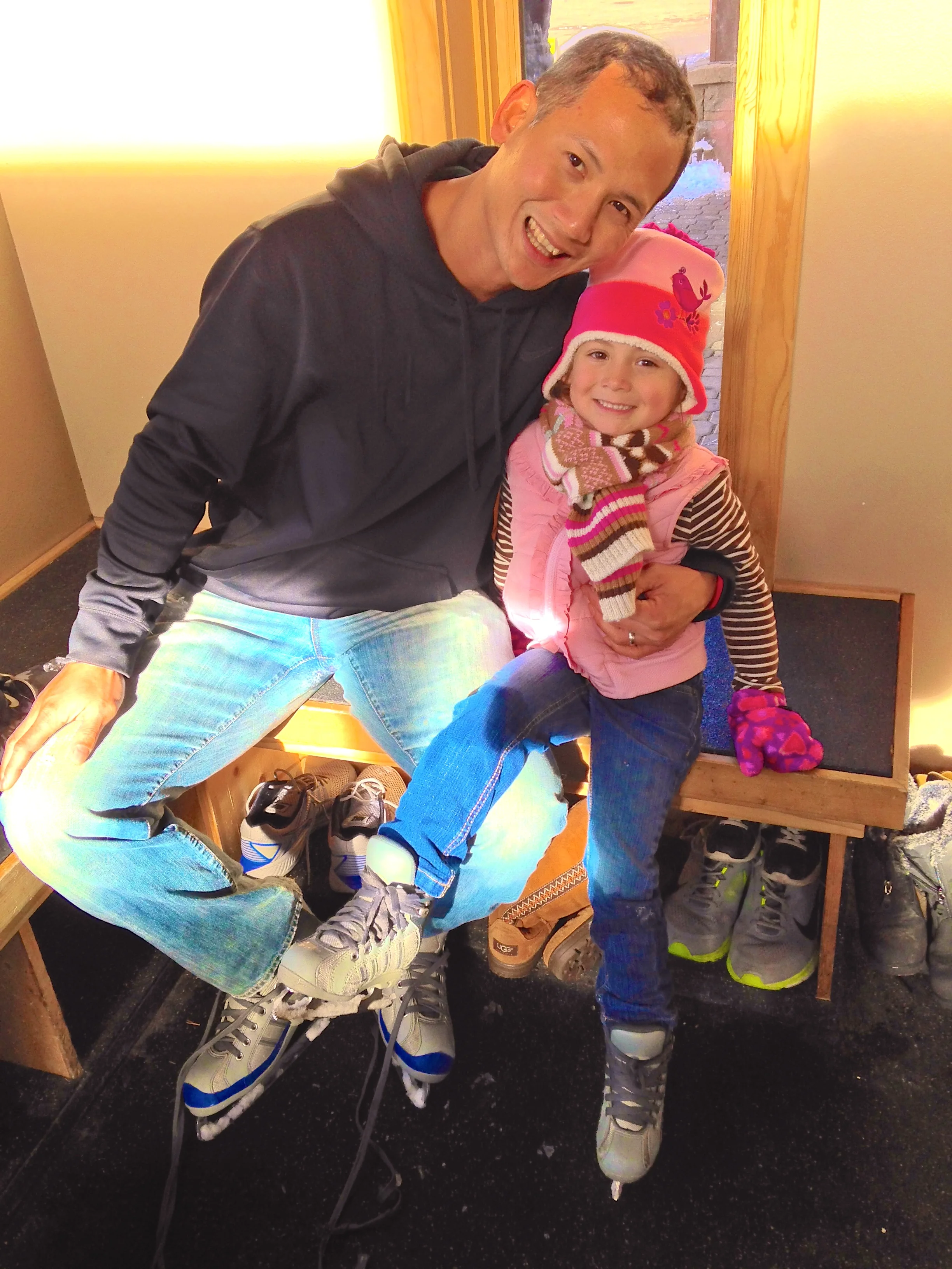 My husband and daughter getting ready to ice skate
