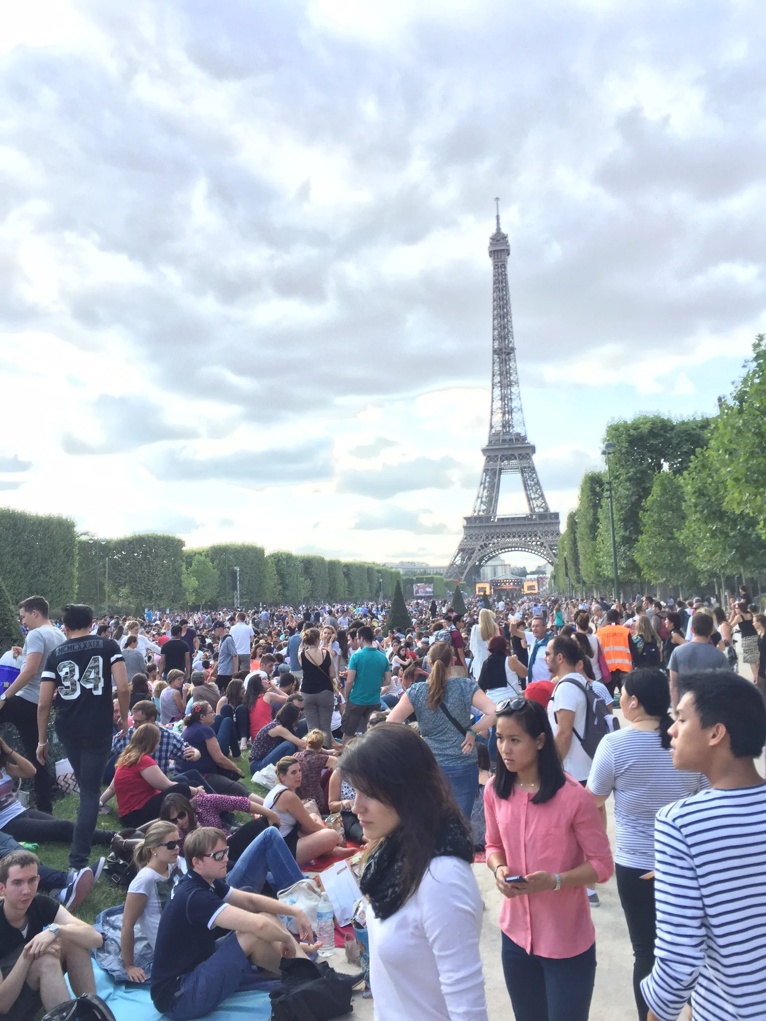 The crowd on the Champ de Mars on Bastille Day 2015. The distant concert stage is lit up under the Eiffel Tower.
