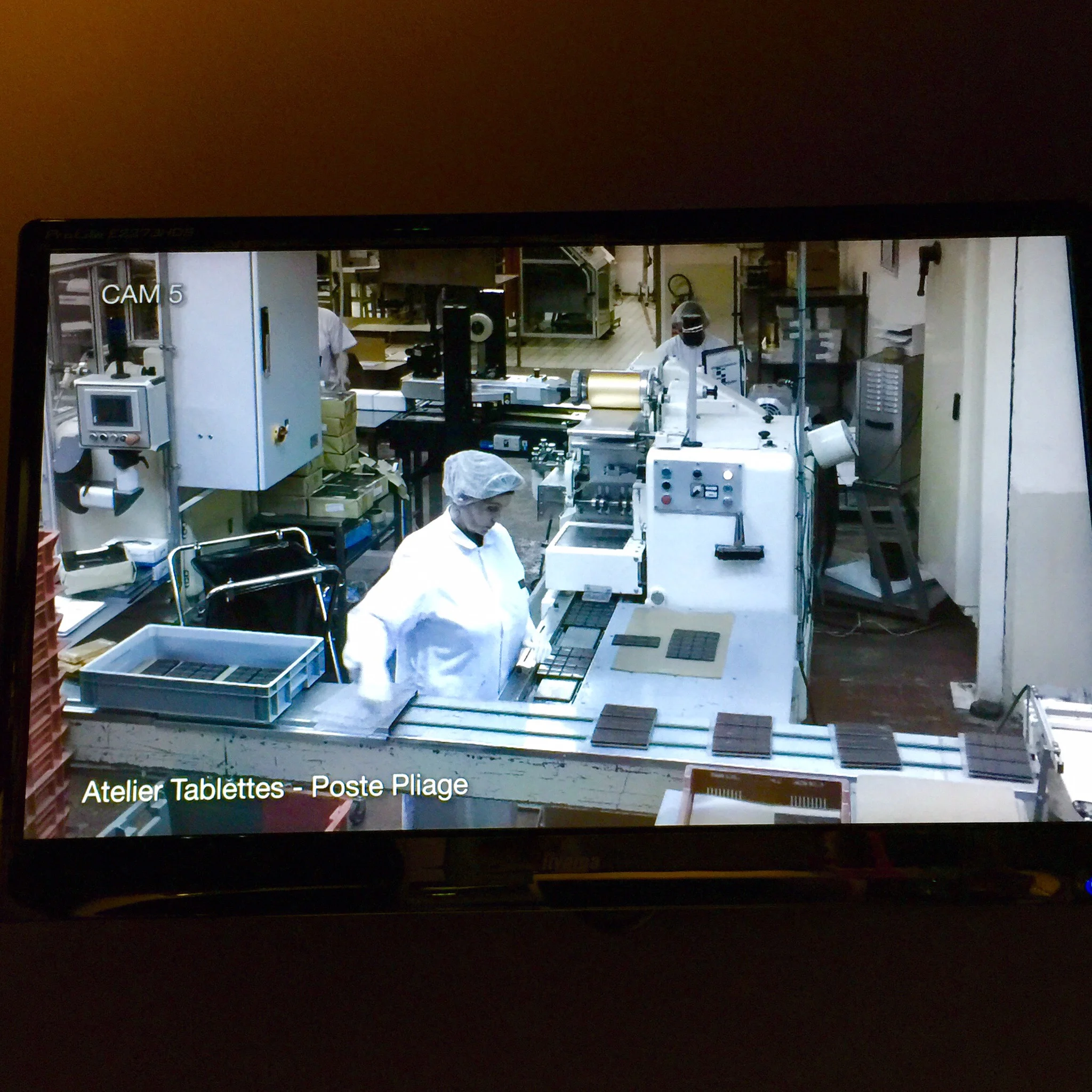 A chocolate factory employee as seen on the webcam
