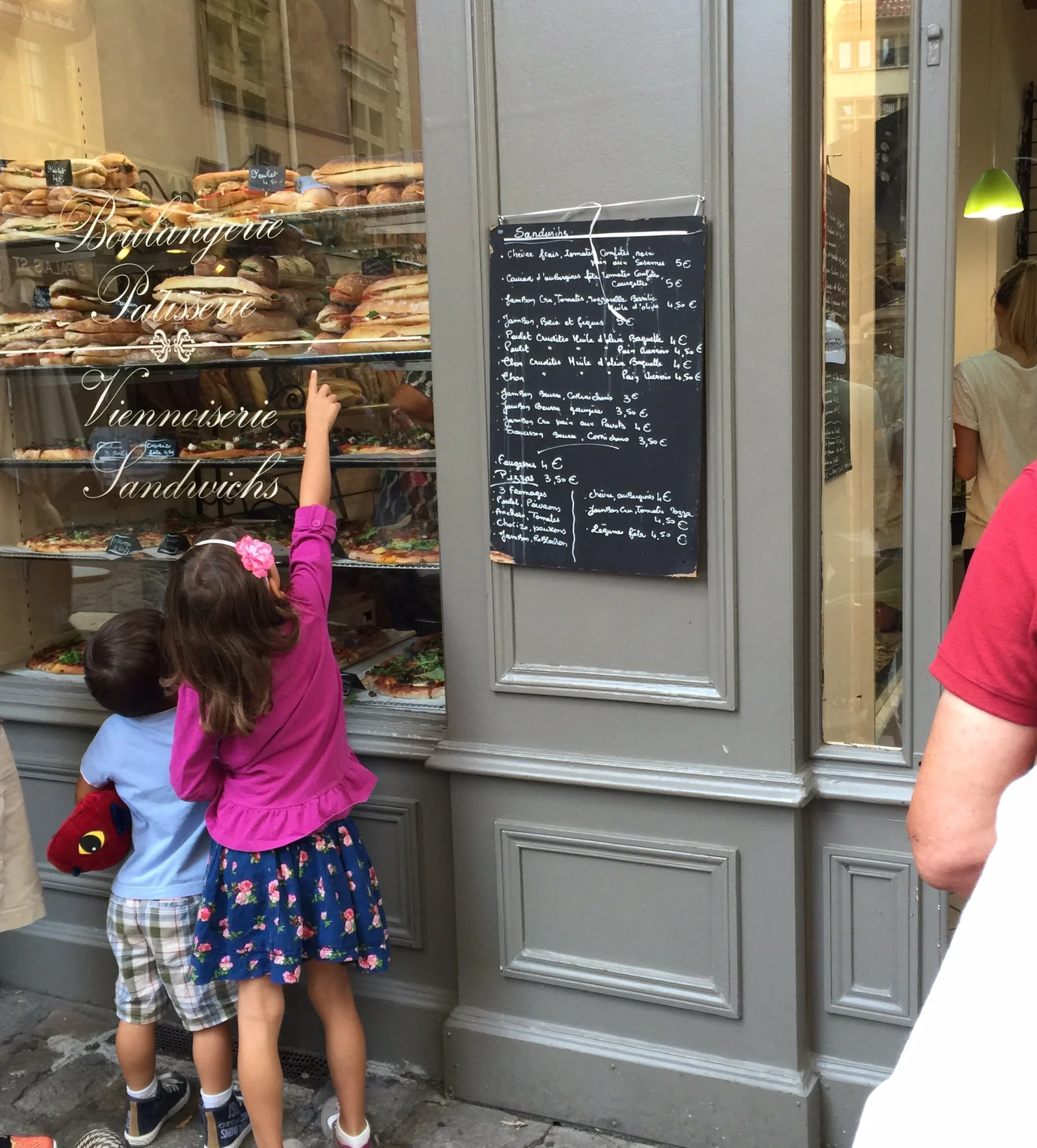 My children picking out a sandwich at a boulangerie --we ate lunches out fairly often before we settled in to our apartment in Lyon