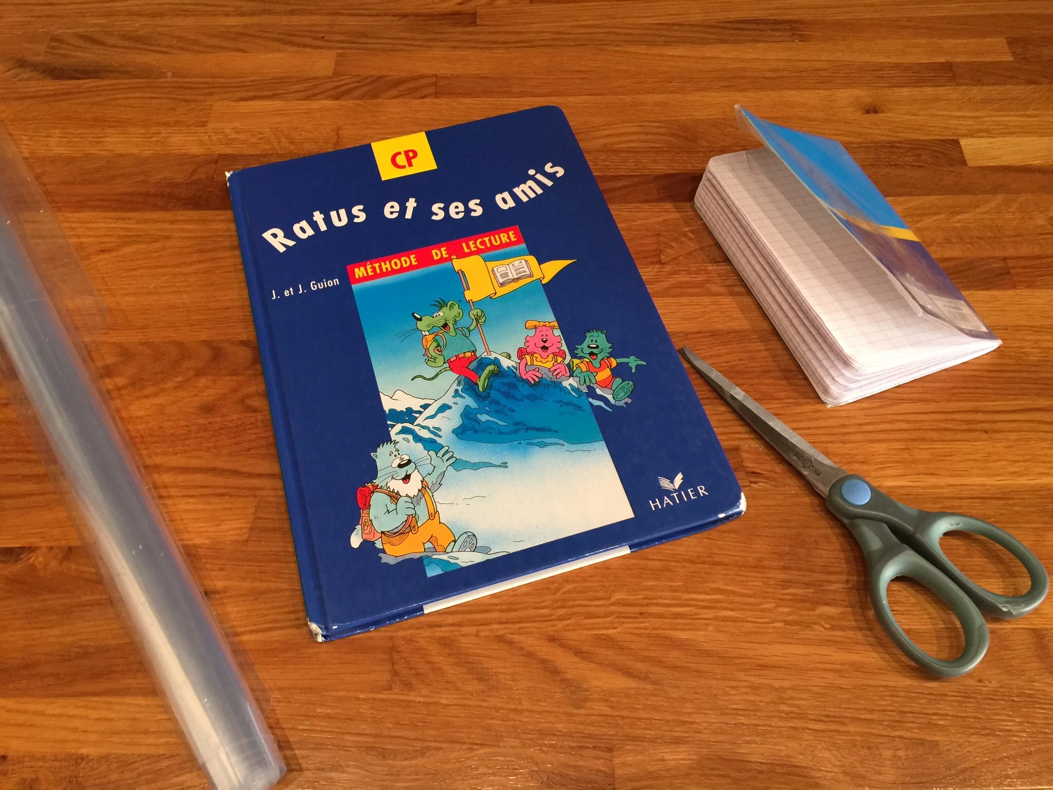 Preparing to cover my daughter's French reading textbook with the required clear plastic