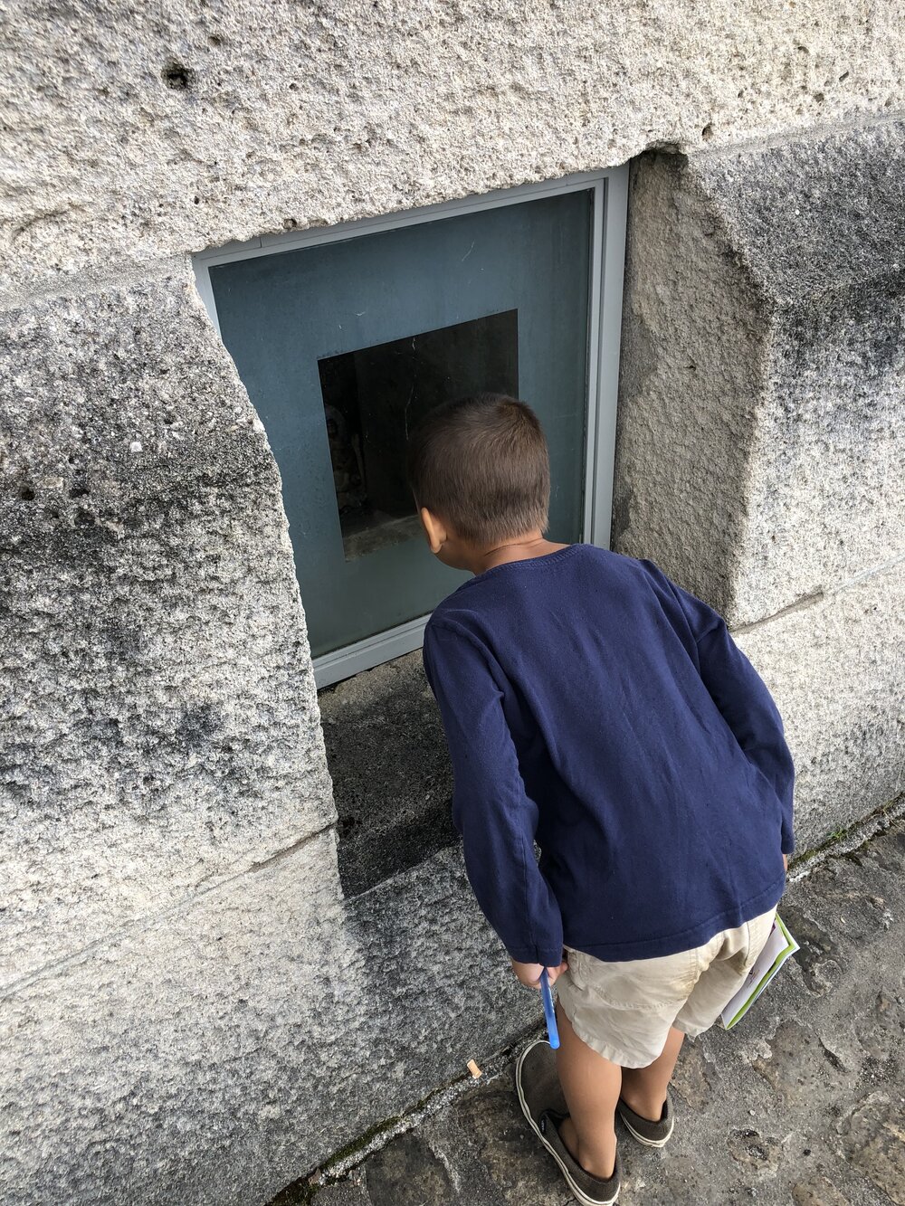 Child looking at verdun douaumont ossuary bones.jpg