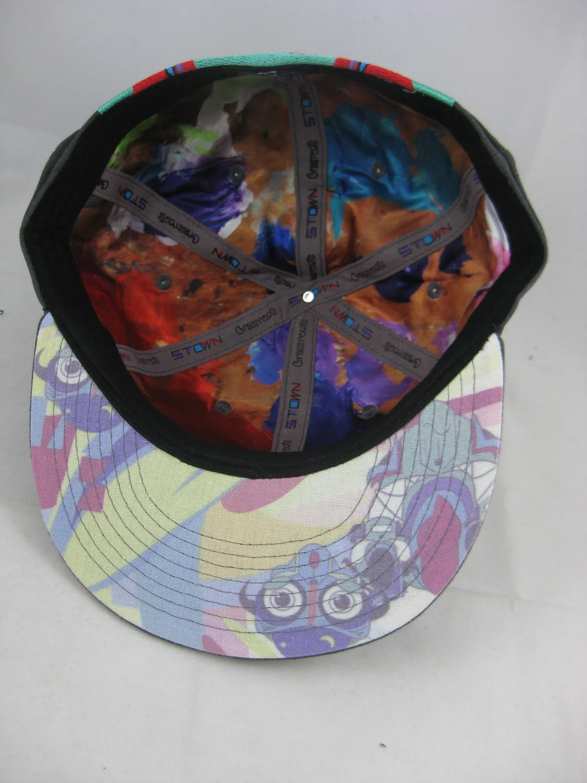 All four hats have satin lining featuring a picture of Spencer Tyler's pallet of colors he paints with as the inner graphic. The under-brim has a soft pastel colored look that complements this unique fitted.