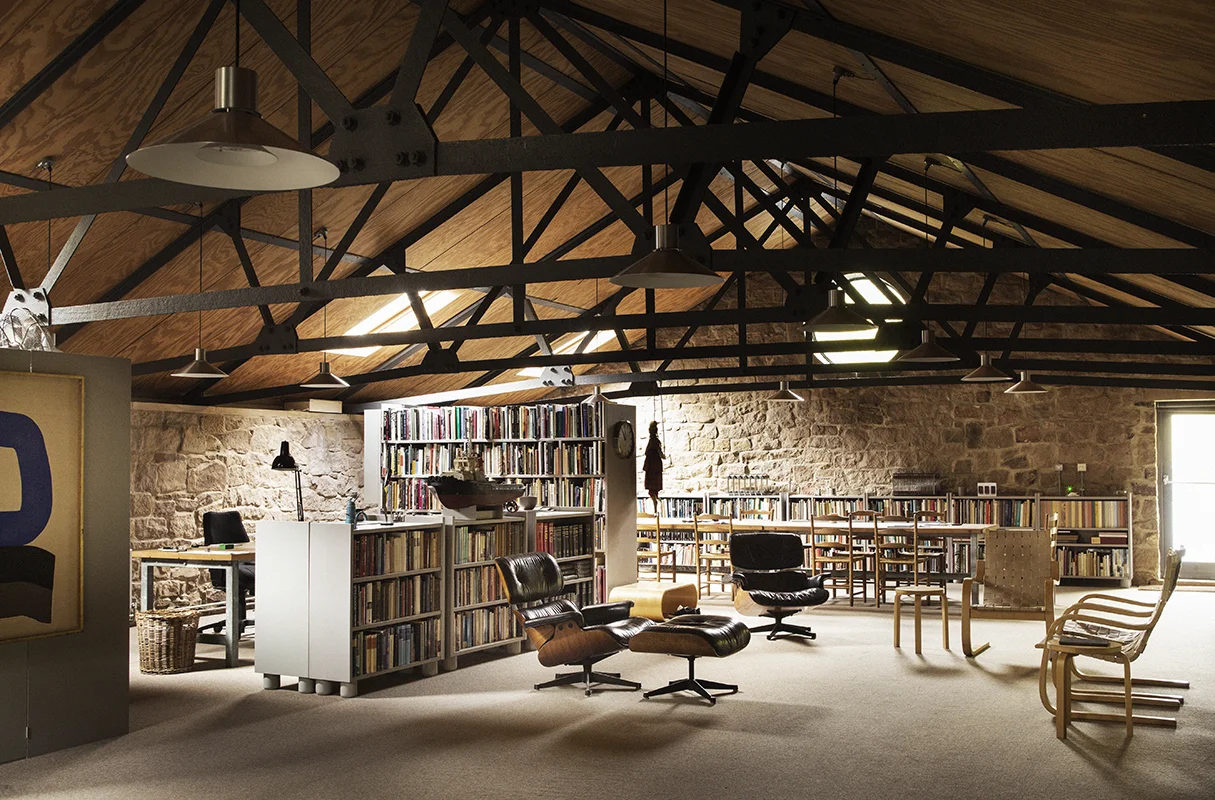 In the library, the black leather chairs are by Charles Eames and the 406 armchairs are by Alvar Aalto.