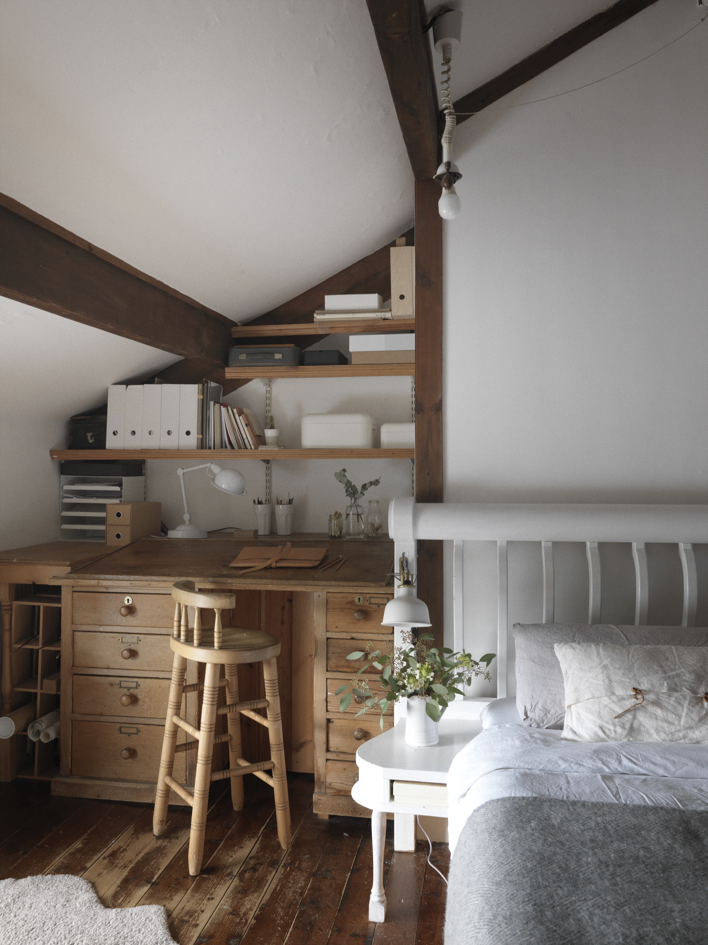 At the moment, the family share a large, open-plan bedroom. The antique desk was in the house when they moved in and this is where Sara sits to record her podcasts.