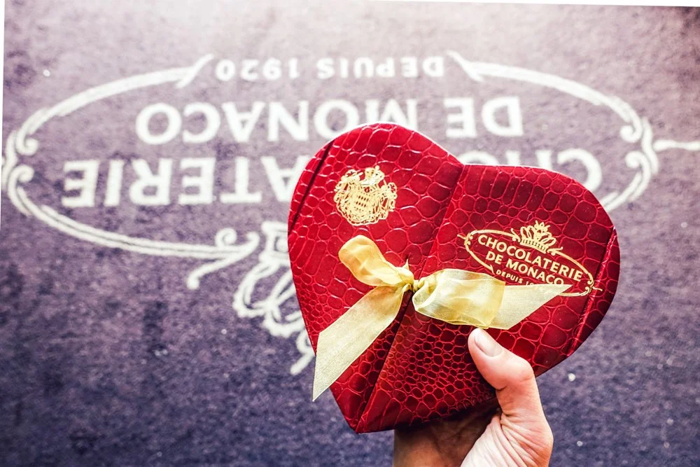 Chocolates in a heart-shaped box, tied with a bow from Chocolatiere de Monaco. What confectionery dreams are made of. 