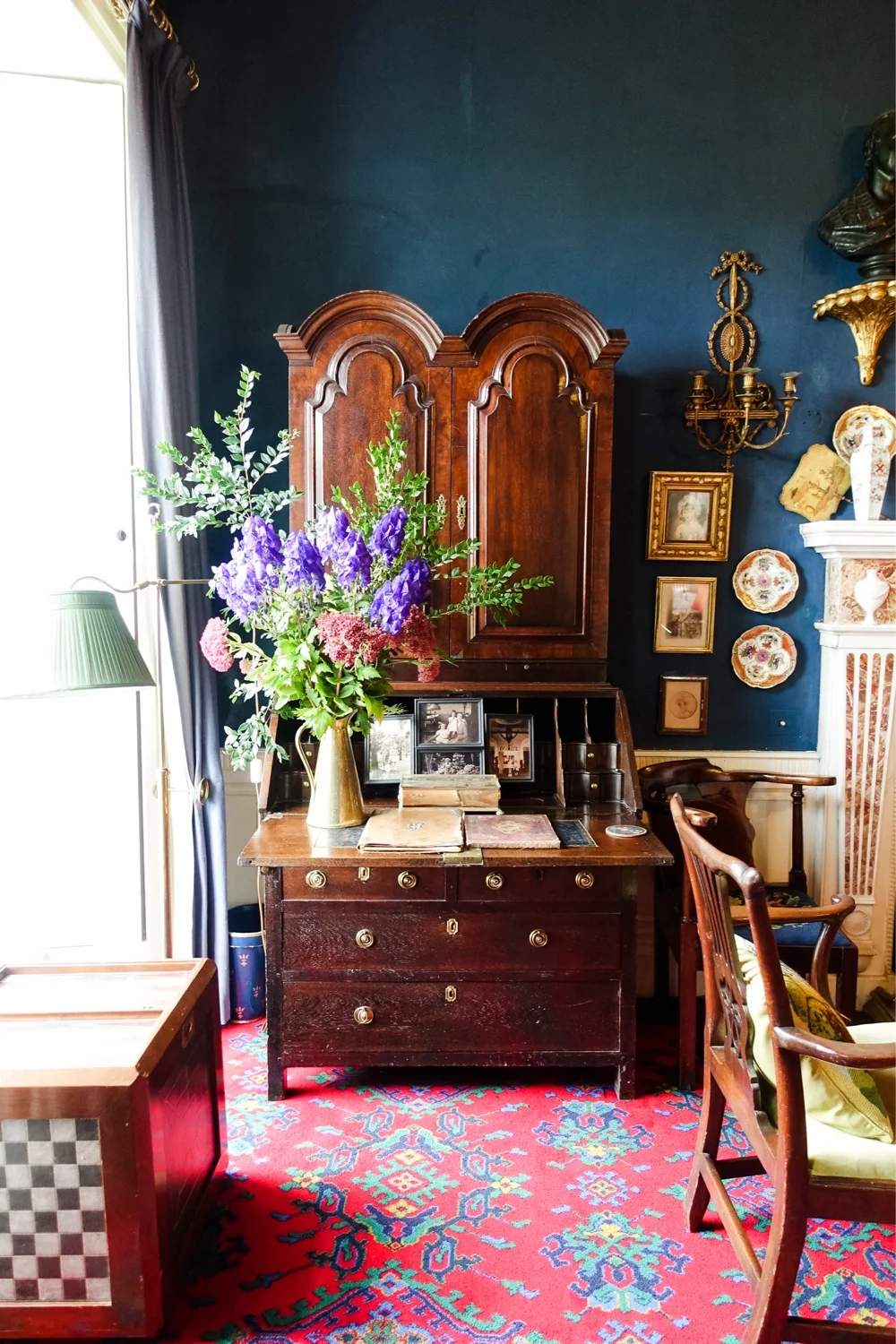 The cosy dark blue-painted library.