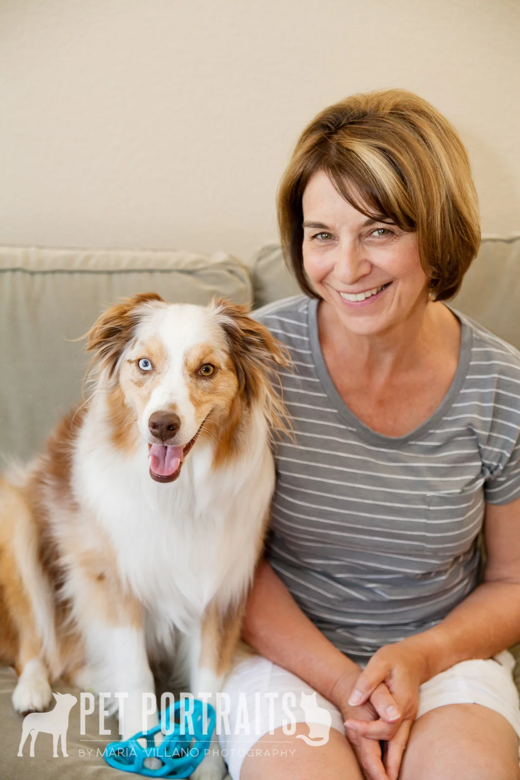 Australian shepard and owner sitting on couch