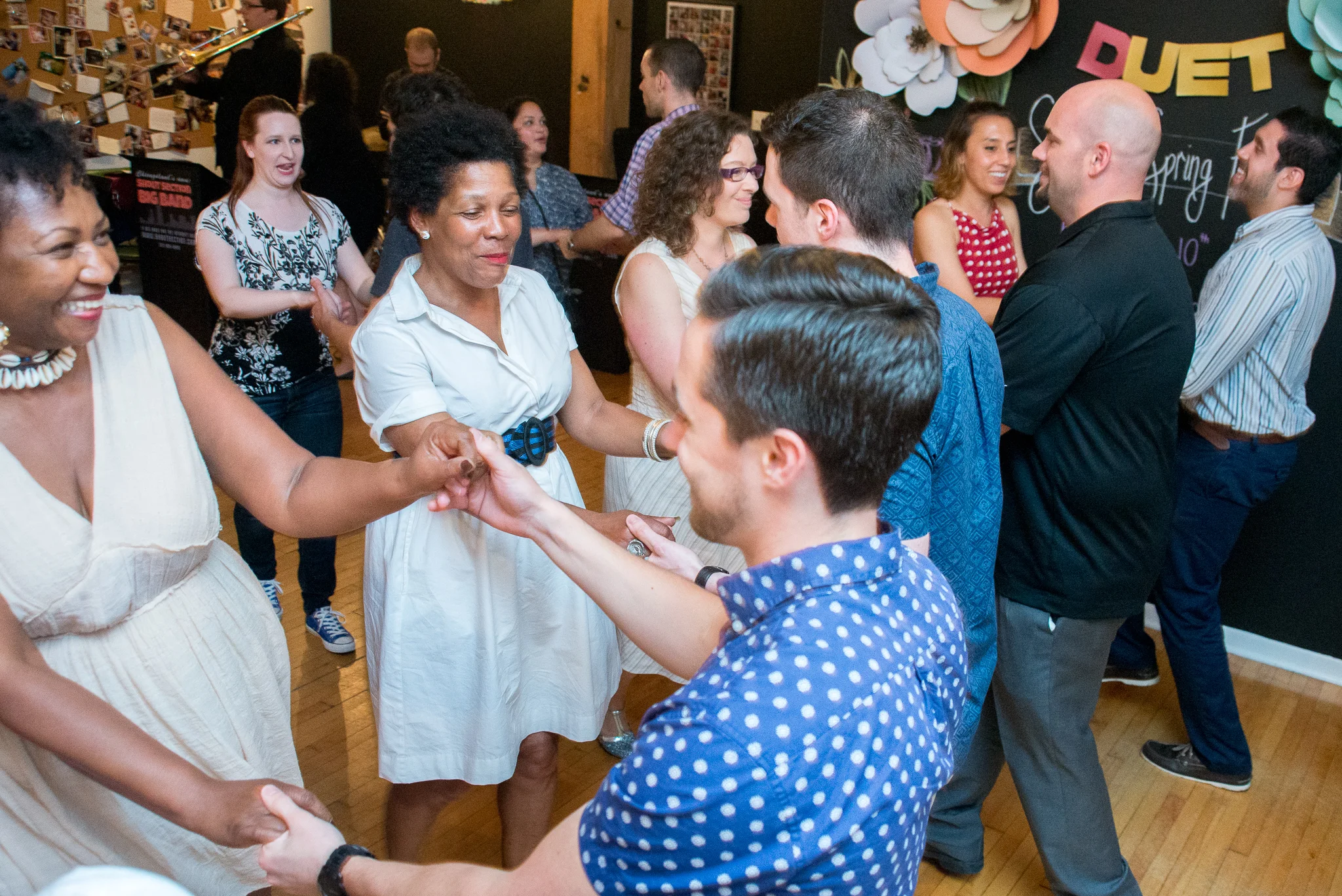 Guests learning to swing and meeting new people at a party.