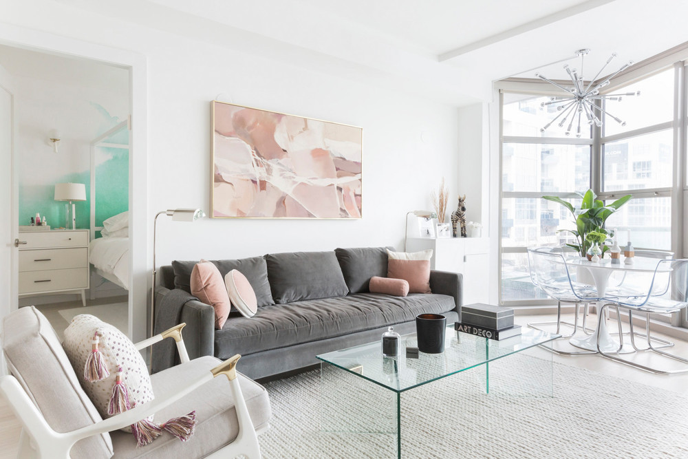 an-nyc-rental-that-looks-straight-out-of-la-grey-sofa-pink-accents-living-room-5a6fa2e2604f27084a0d4a87-w1000_h1000.jpg