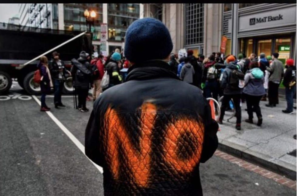Suzanne Gardinier of New York City made her feelings about Mr Trump known as she followed a group of protesters. (Michael S Williamson/The Washington Post)