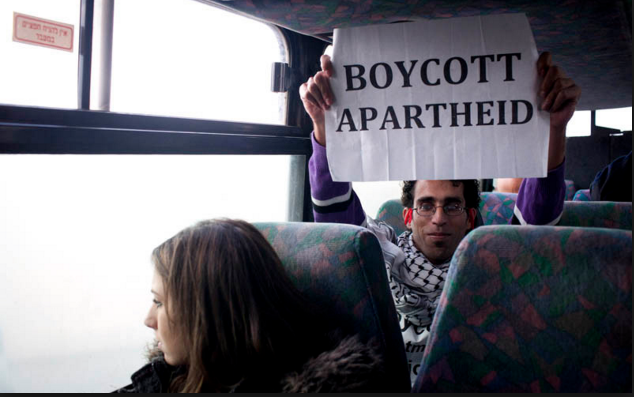 Basel al Araj on a settlers' bus. Photo via Electronic Intifada.