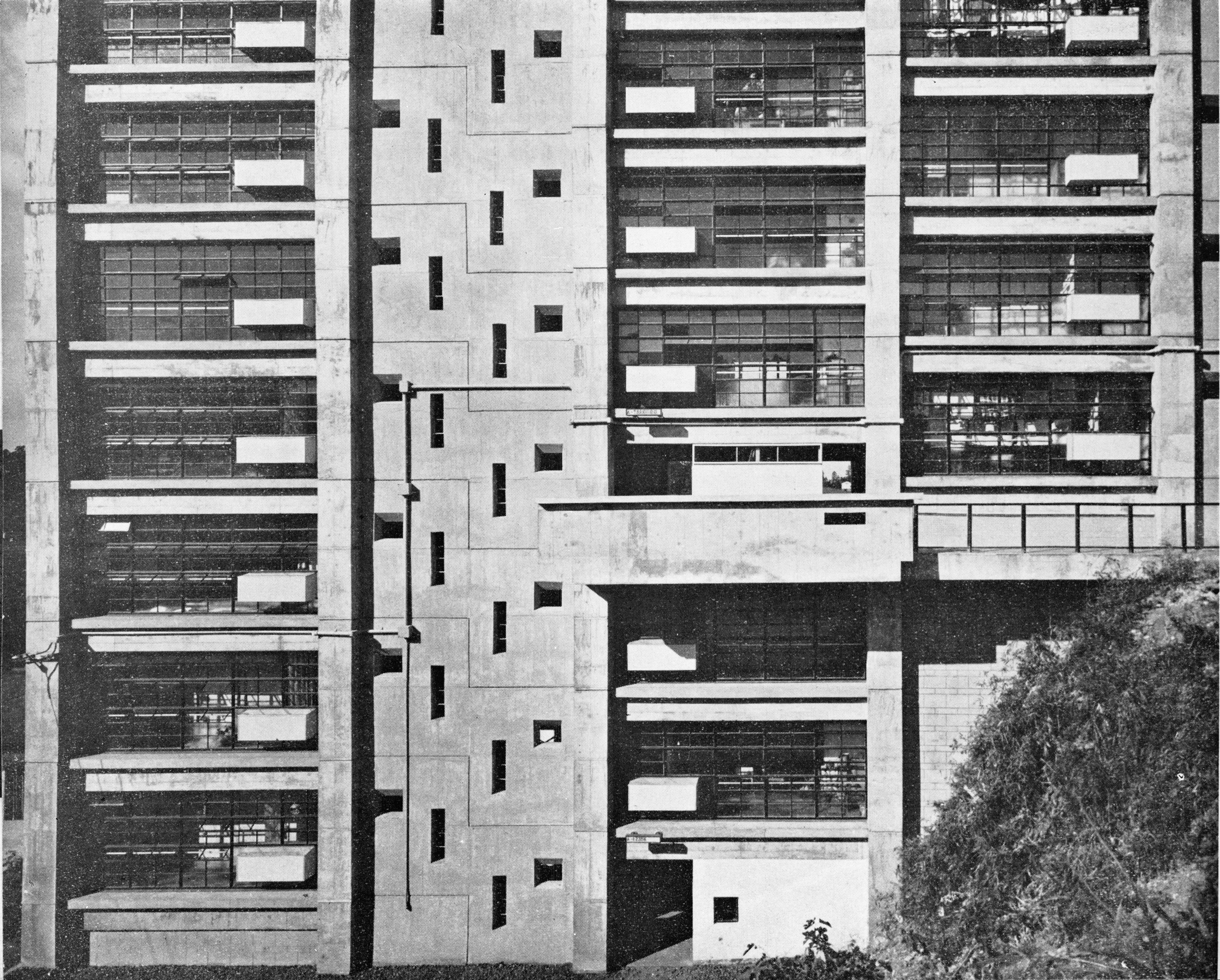 (Japan Architect 1956-57 , pg. 30, photos Y. Ishimoto ) Building elevation (white rectangular protrusions are attached shoe-boxes)