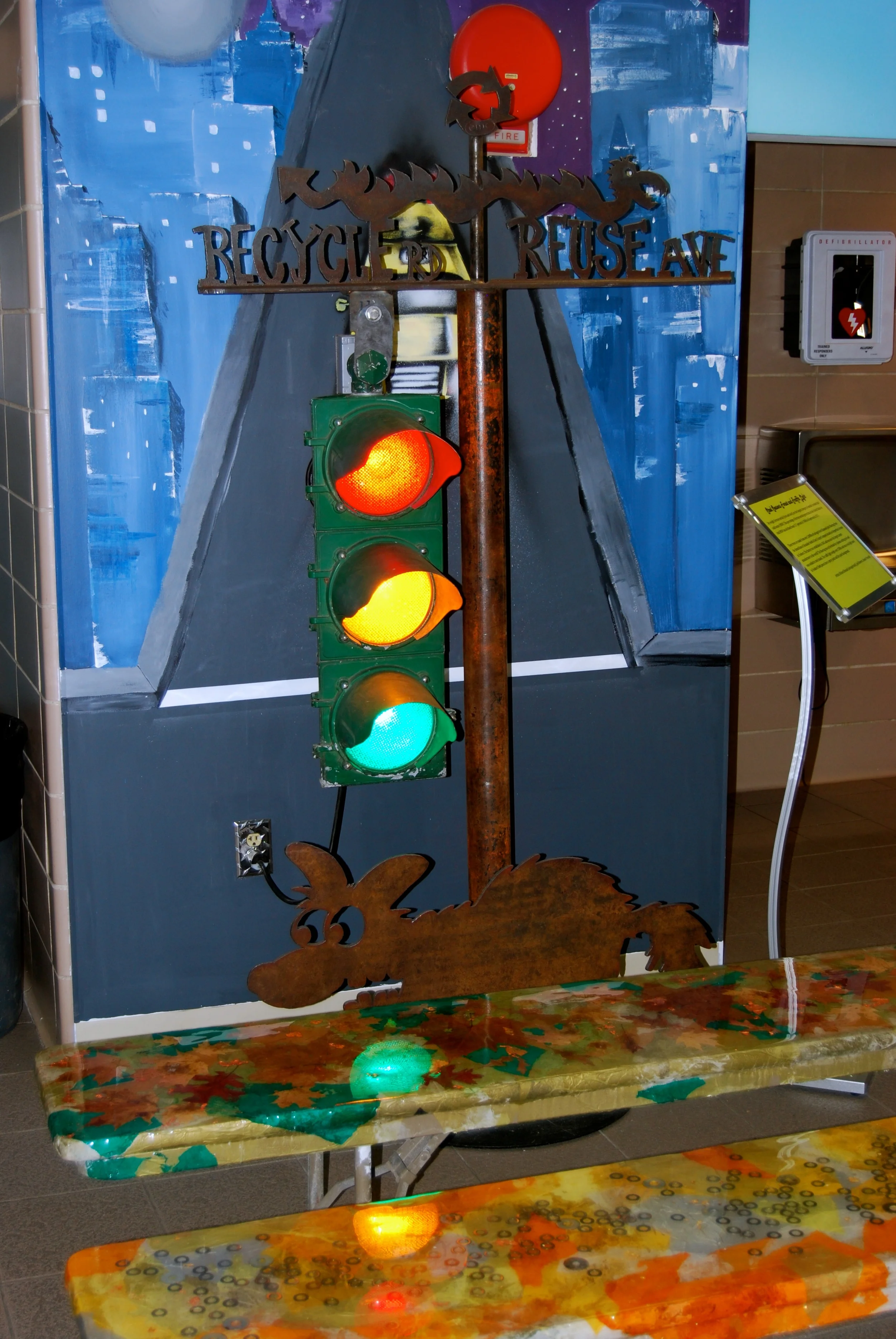 Richard's salvaged steel street light sculpture along Shelita's with up-cycled benches at the MRF. 